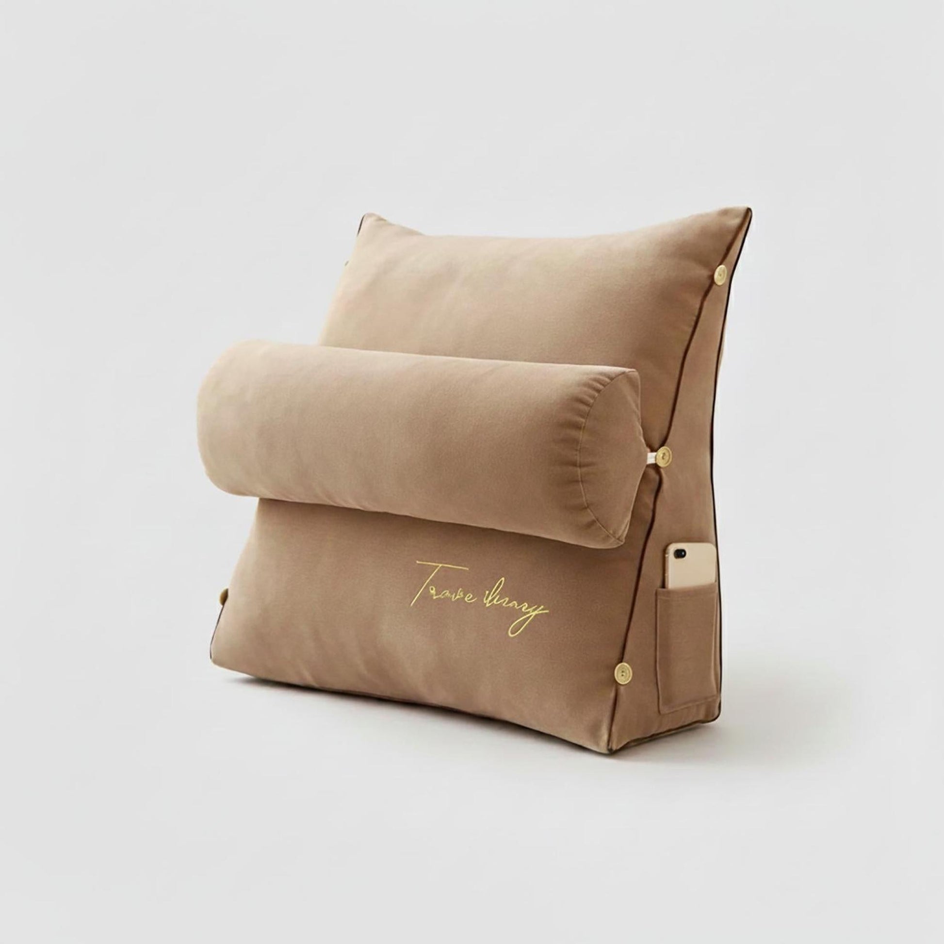 Beige ergonomic wedge pillow with a removable bolster, side pocket, and gold "Trave Sunny" embroidery.