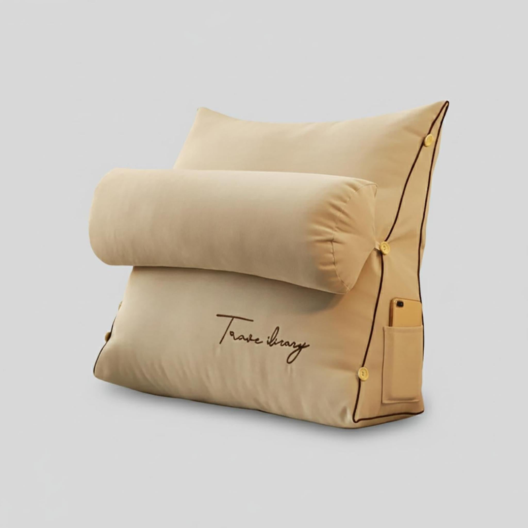 Beige ergonomic wedge pillow with a detachable bolster, side pocket, and "Travel library" embroidery.