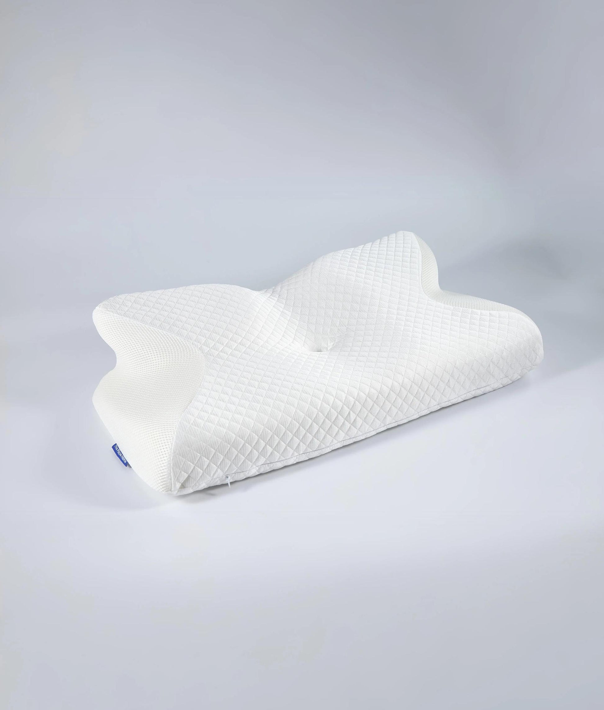 White ergonomic memory foam neck pillow with a butterfly shape and quilted texture.