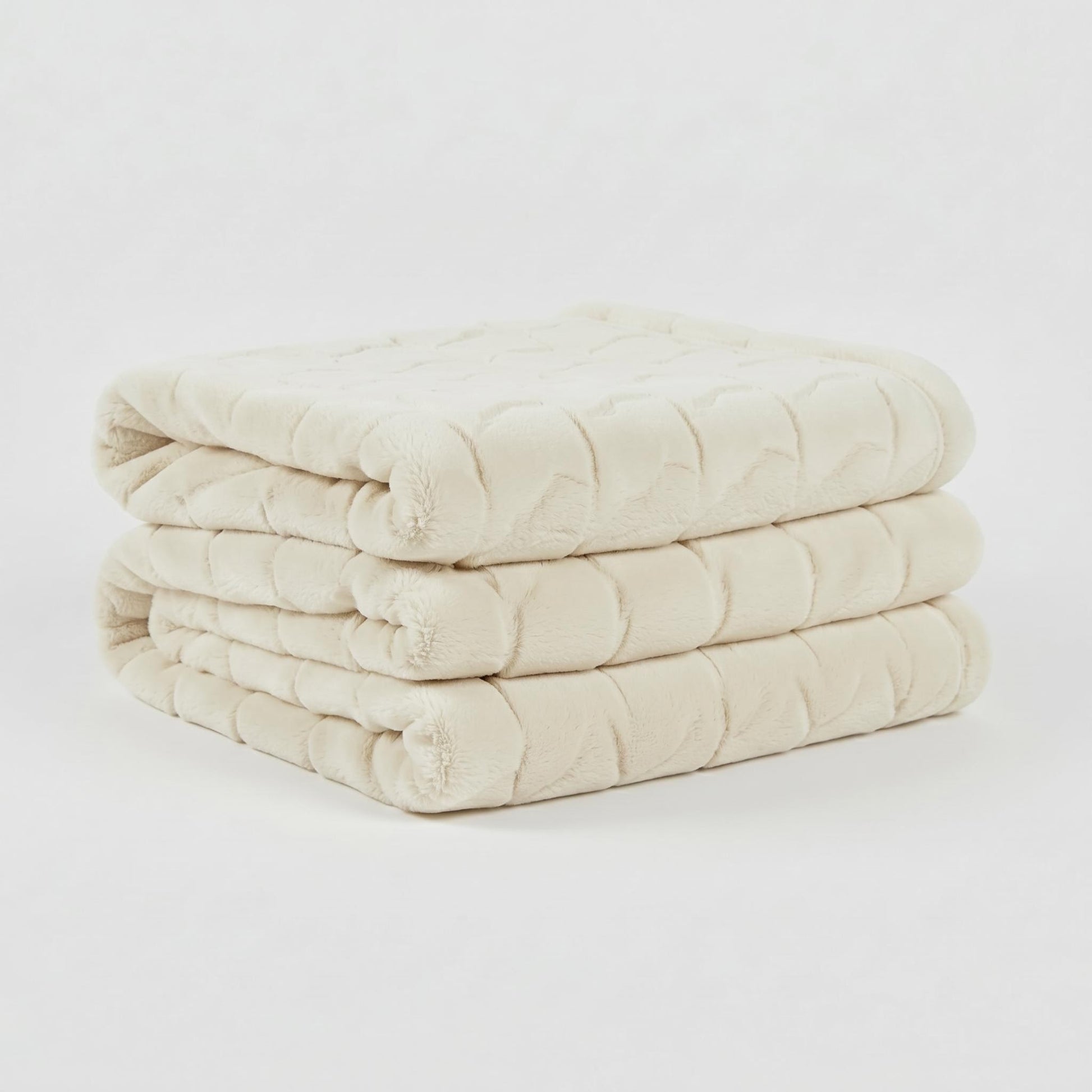 Soft, plush cream faux fur throw blanket, folded neatly, showcasing its textured tatting design.