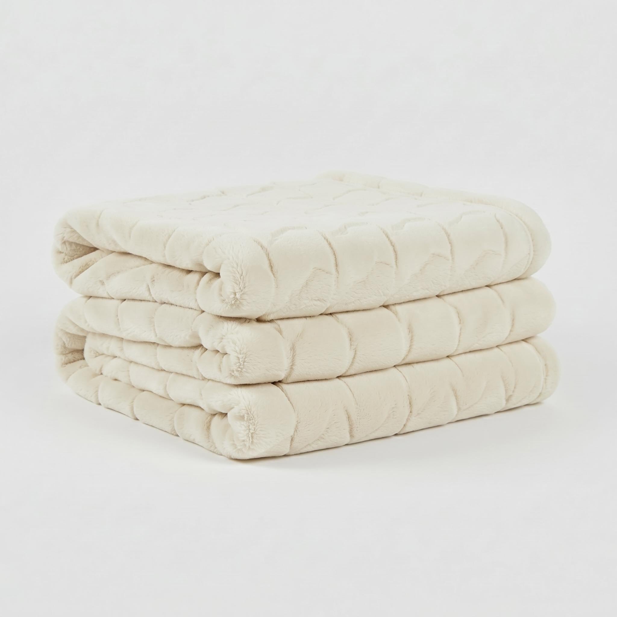Soft, plush cream faux fur throw blanket, folded neatly, showcasing its textured tatting design.