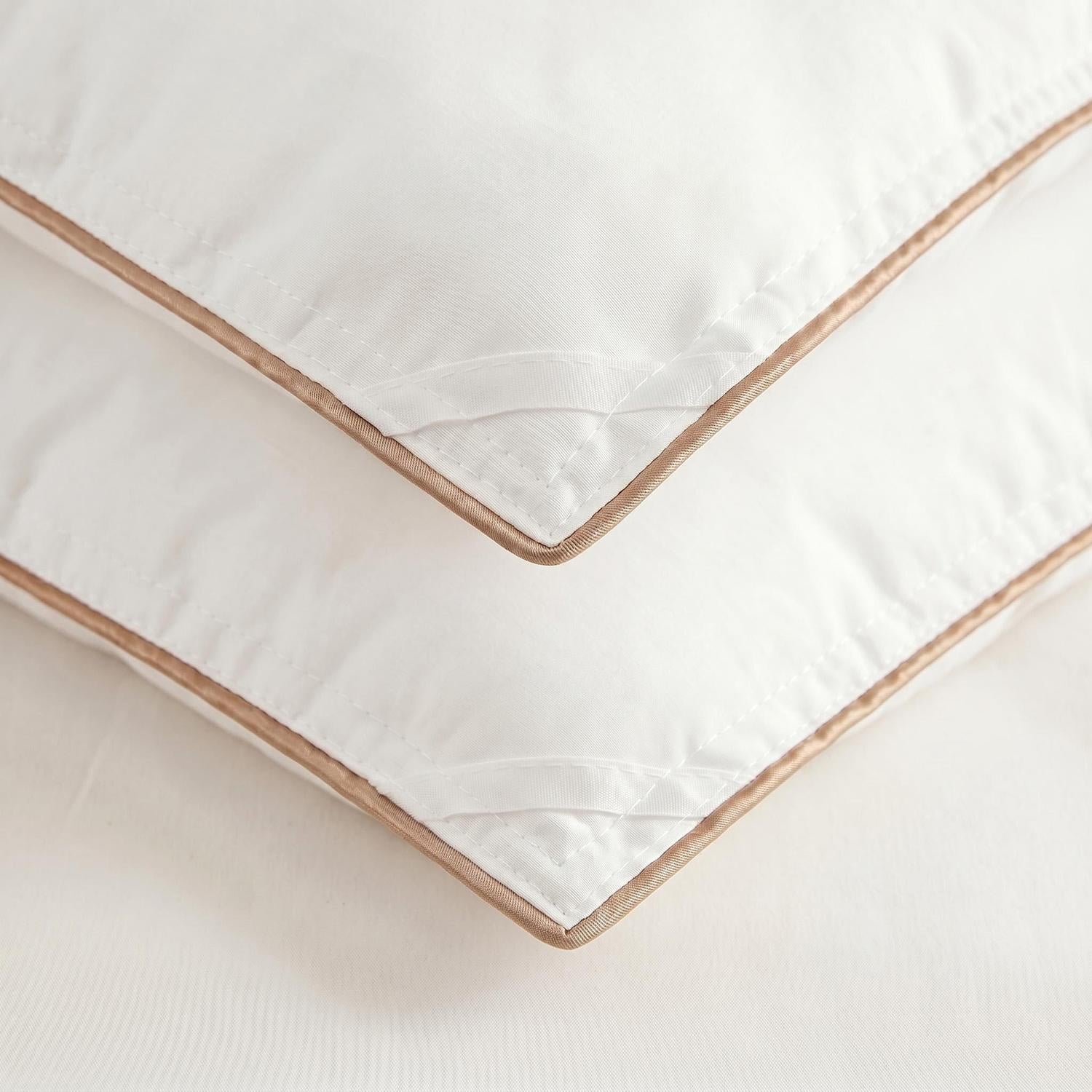 White cotton goose down comforter with elegant brown piping and quilted corners.