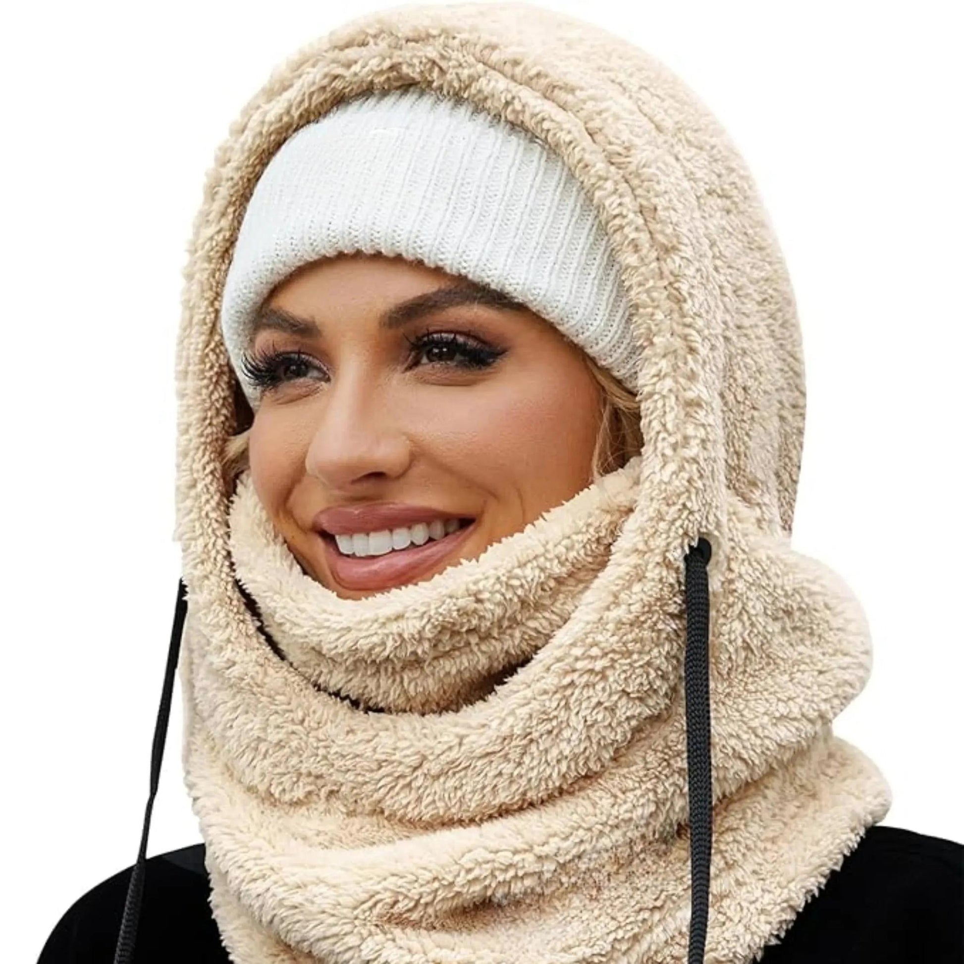 Woman wearing a beige plush fleece hooded beanie scarf with a white knit beanie underneath.