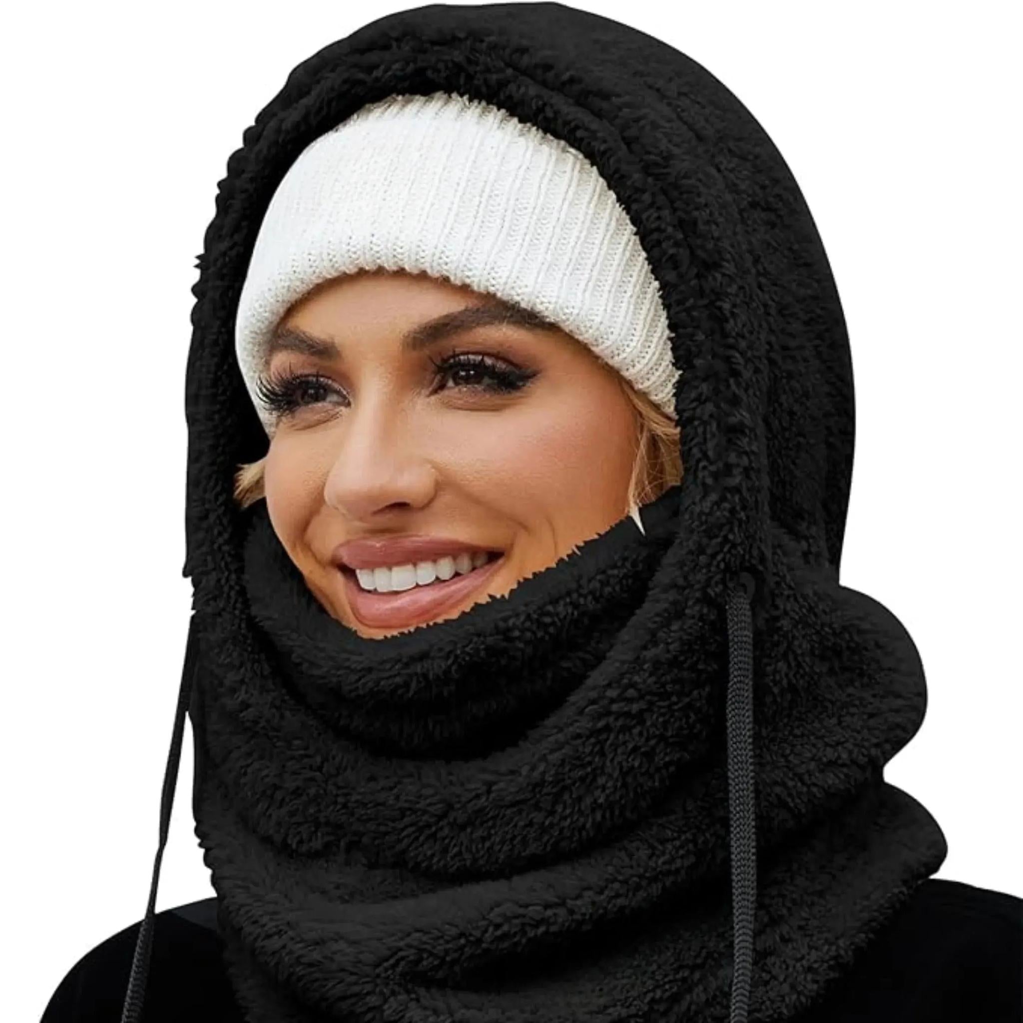 Woman wearing a black fleece-lined hooded beanie scarf over a white knit beanie.