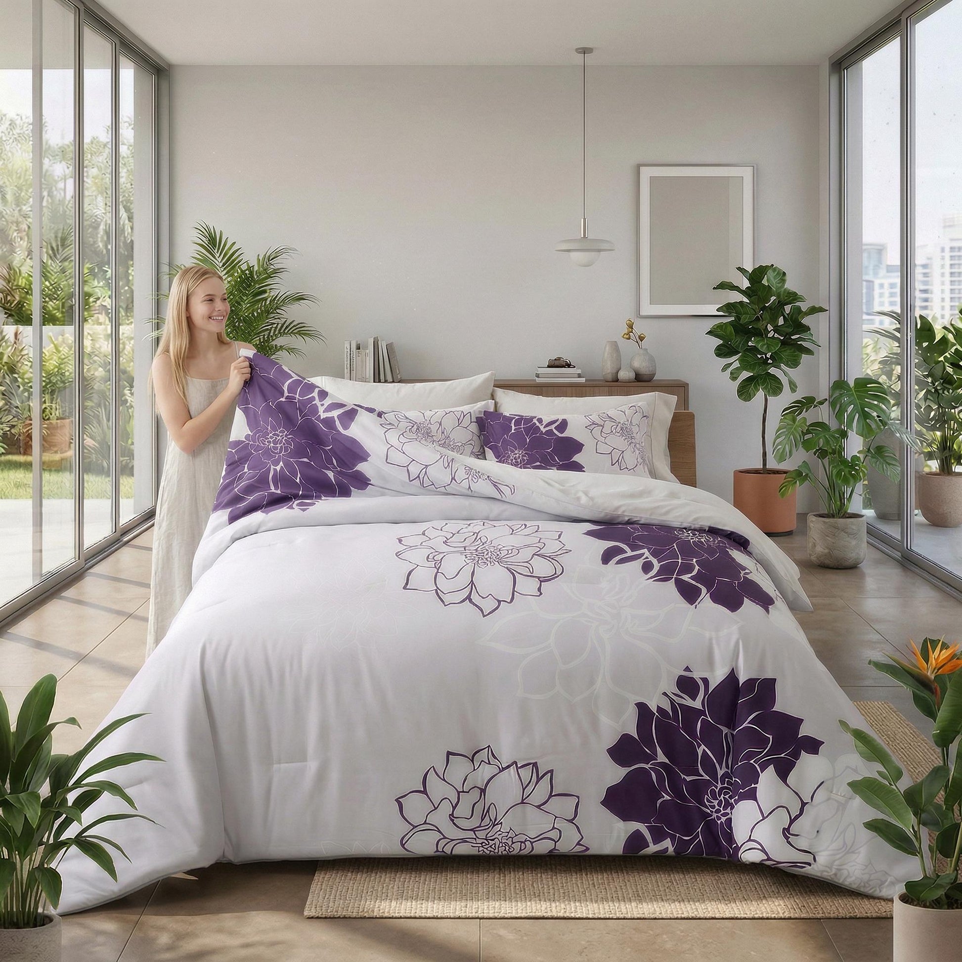 Woman holding a white microfiber floral bedding set with bold purple dahlia patterns.