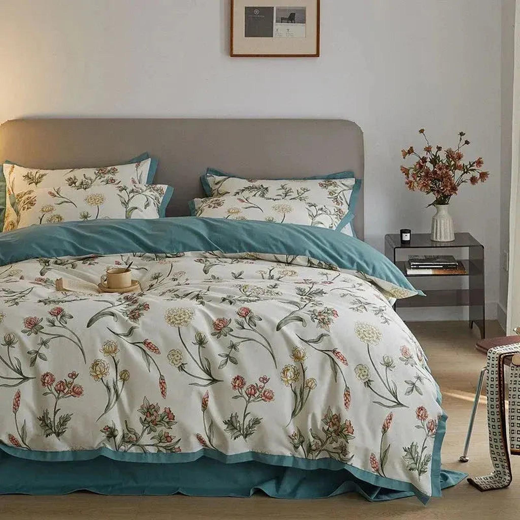 White microfiber floral duvet cover set with teal trim, featuring a botanical pattern on a bed.