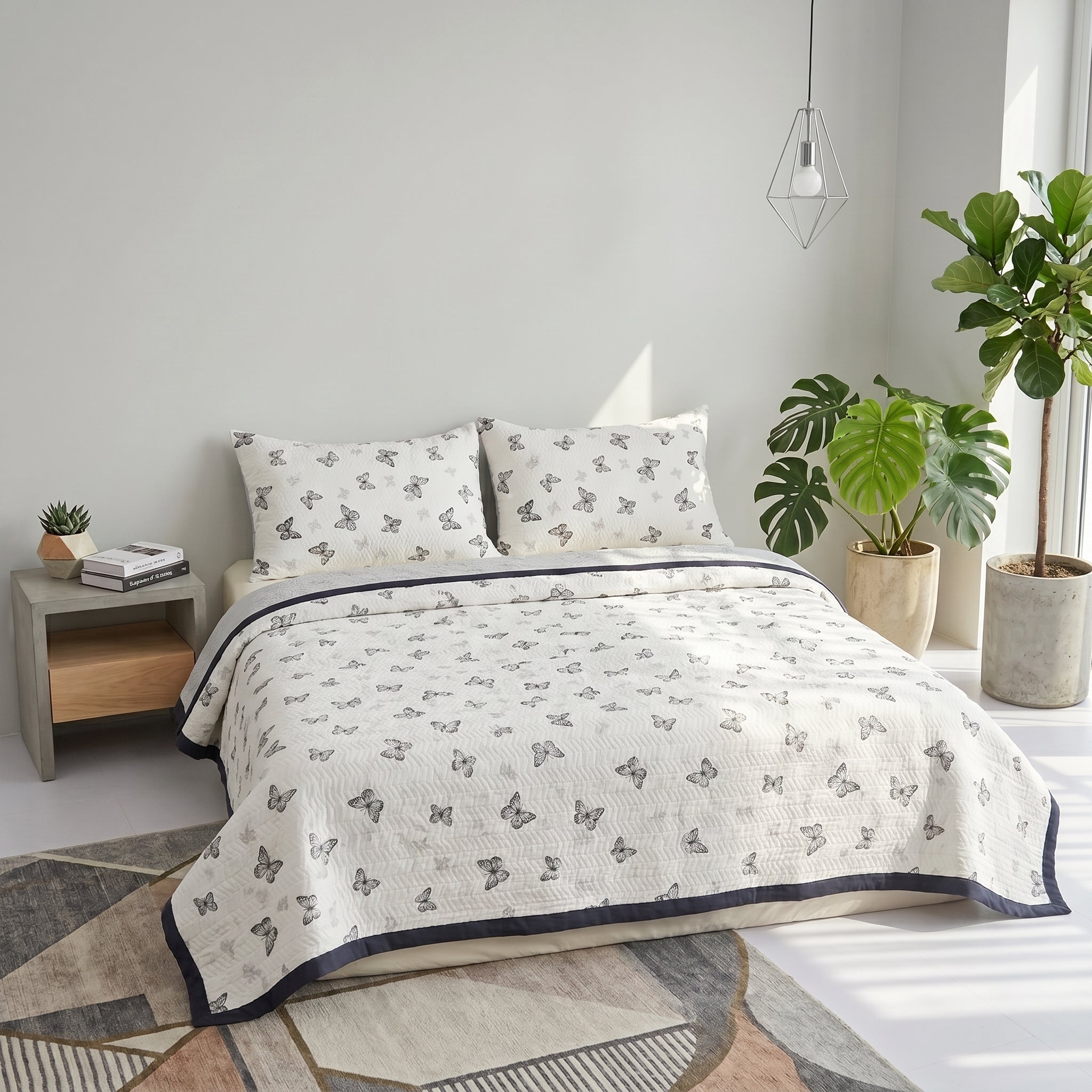 White microfiber quilt bedding set with a gray butterfly pattern and navy trim.