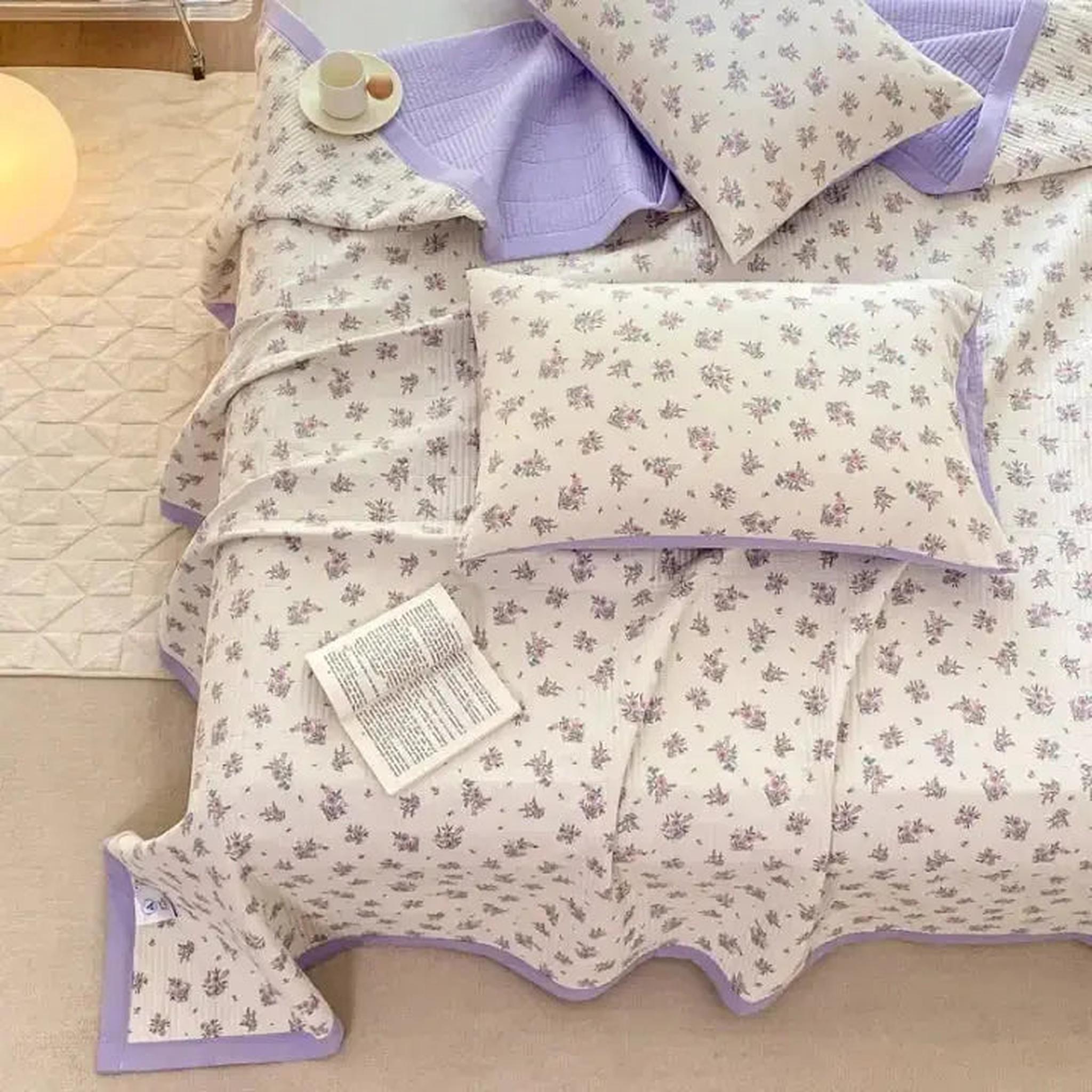 White microfiber quilt bedding set with delicate purple floral pattern and solid lavender trim.