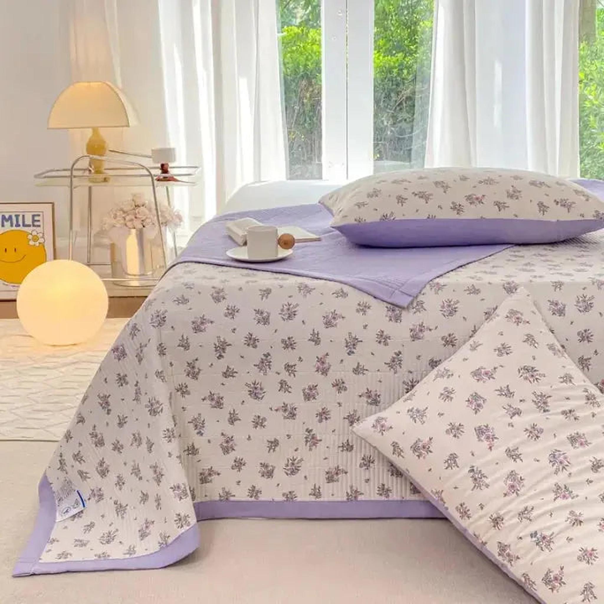 White microfiber quilt bedding set with purple floral pattern and solid lavender trim.