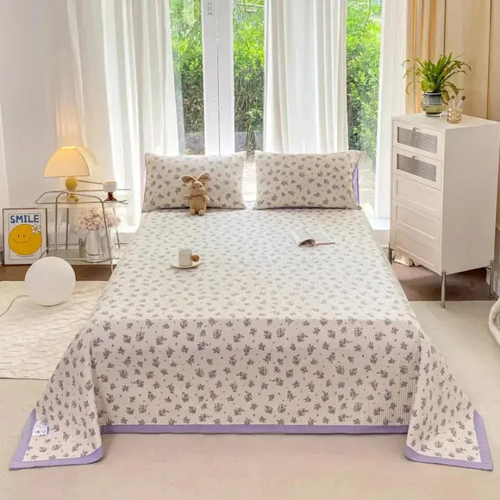 White microfiber quilt bedding set with delicate floral pattern and lavender trim.