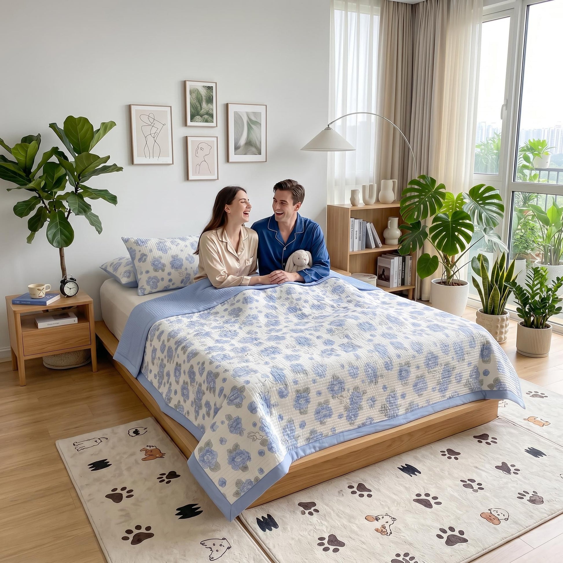 Couple on a bed with a blue and white floral microfiber quilt bedding set in a bright bedroom.