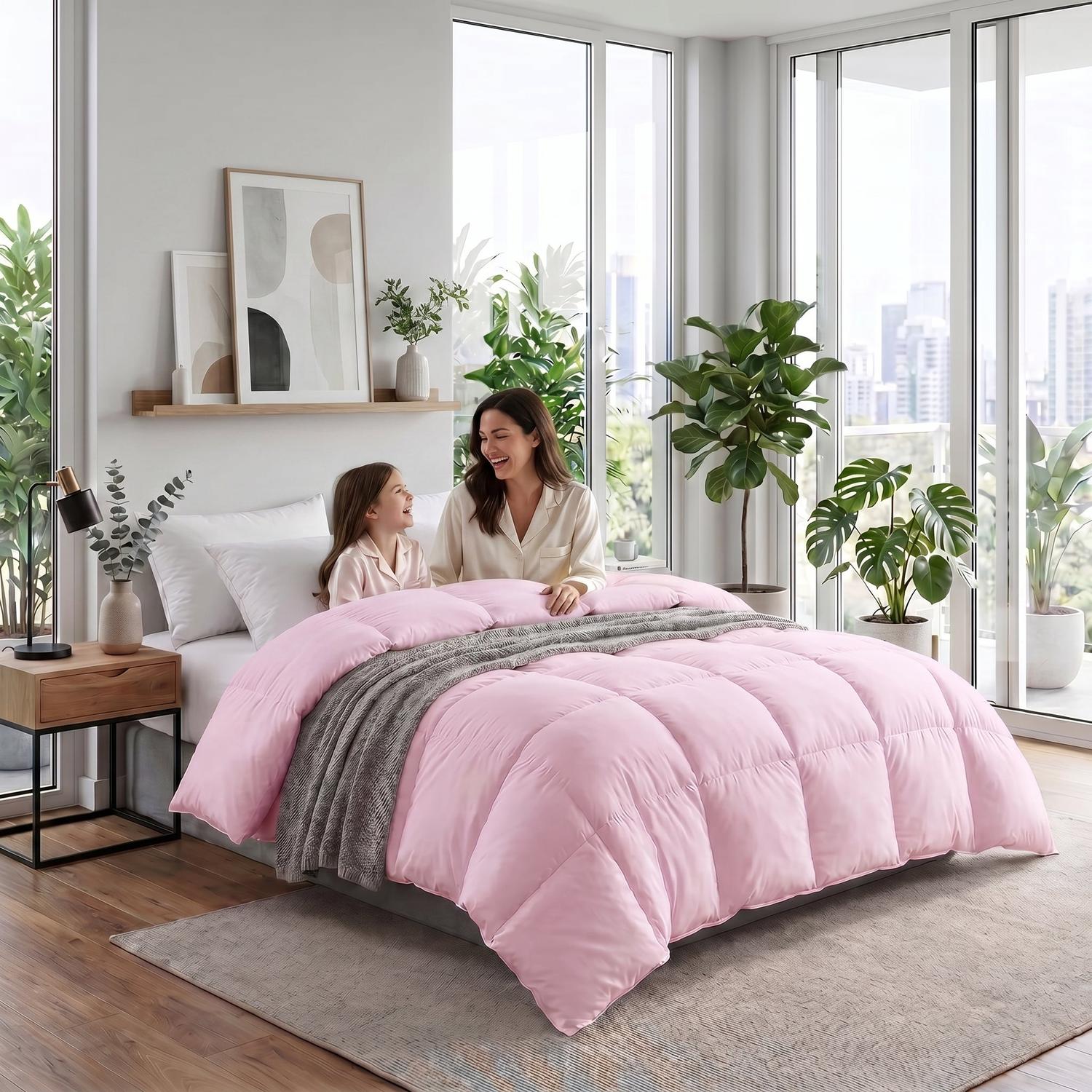 Mother and child on a bed with a fluffy pink cotton duvet insert comforter and gray throw blanket.