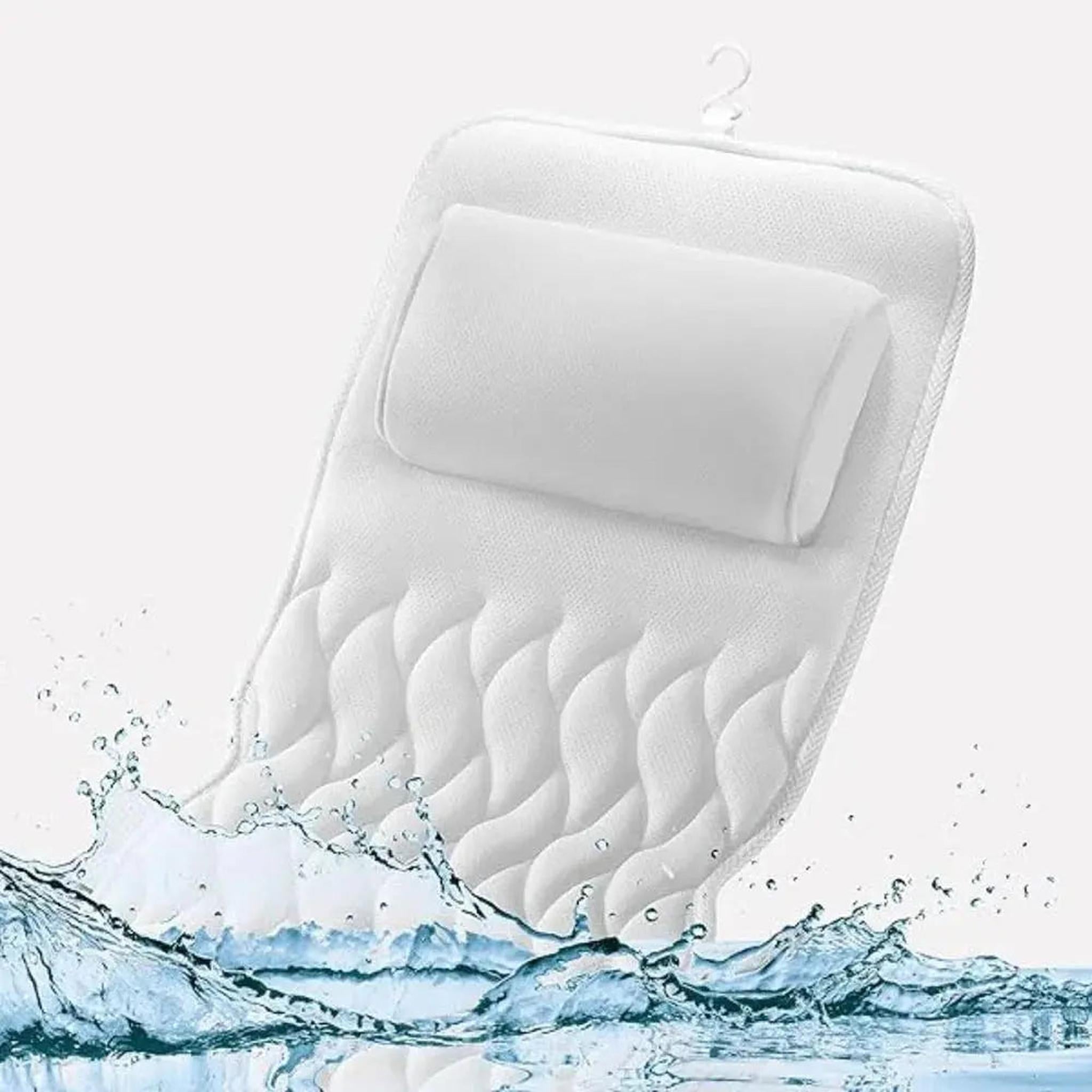 White full body bath pillow with a built-in headrest and quilted mesh design splashing in water.