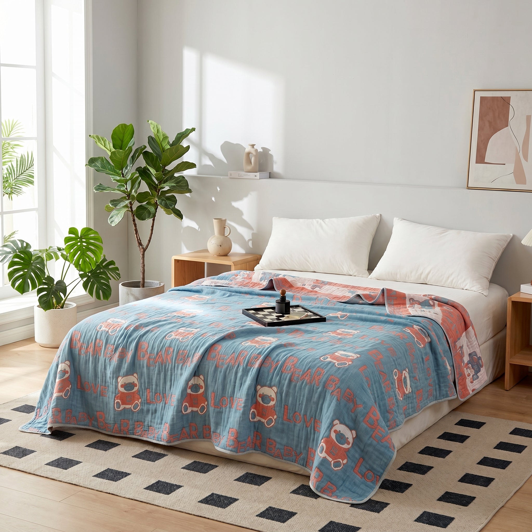 Blue 6-layer cotton gauze blanket with red bear and "LOVE" print on a bed in a bright bedroom.