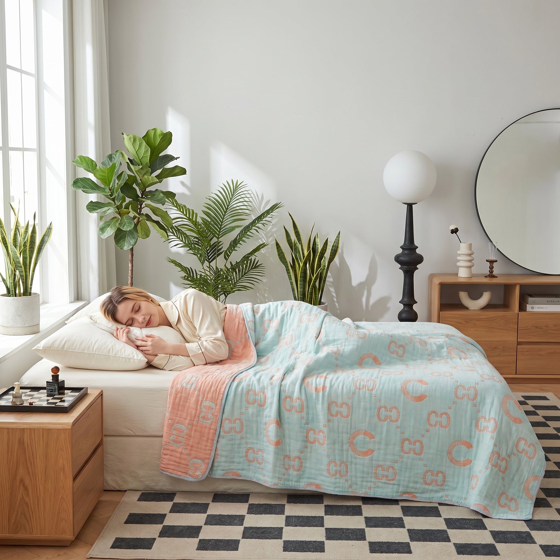 Woman sleeping under a reversible 6-layer cotton gauze blanket in light blue and peach with a subtle pattern.