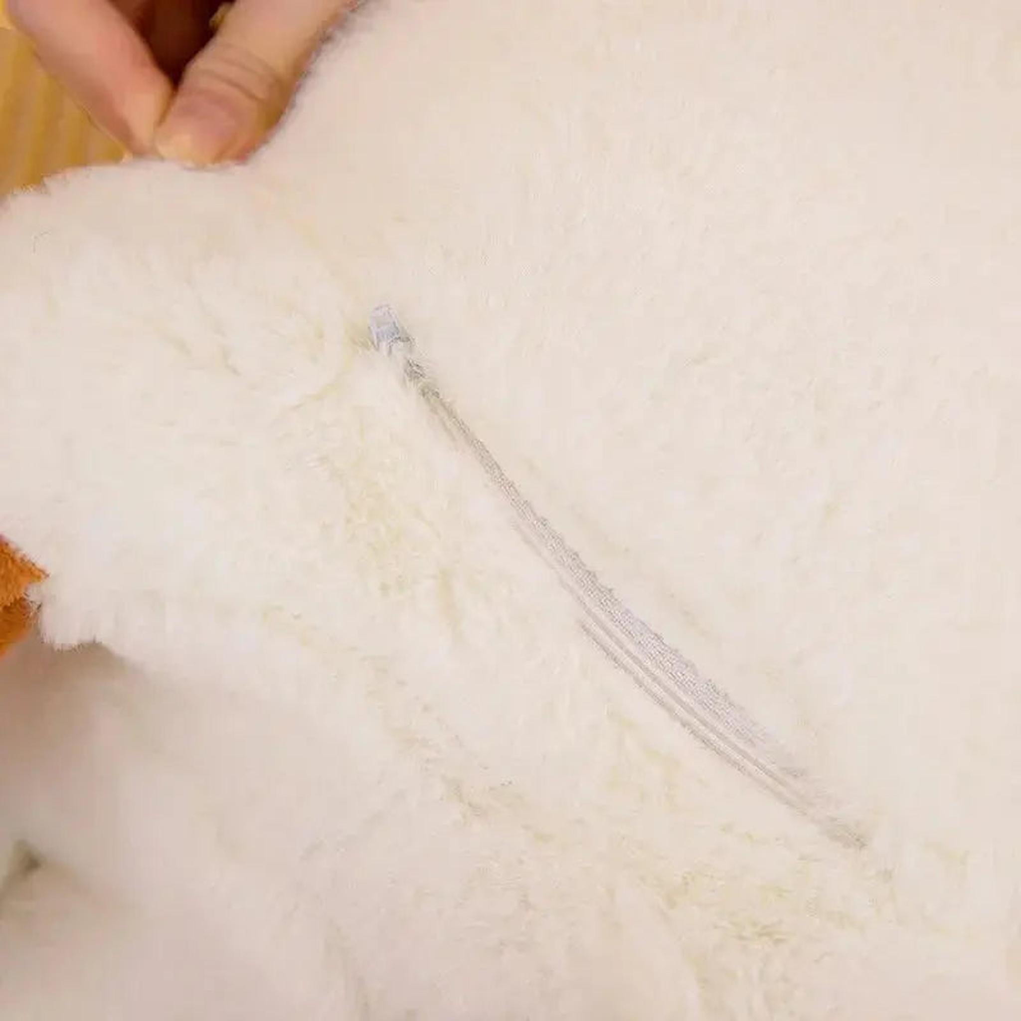 Close-up of a white goose plush pillow showing the soft fabric texture and a zipper.