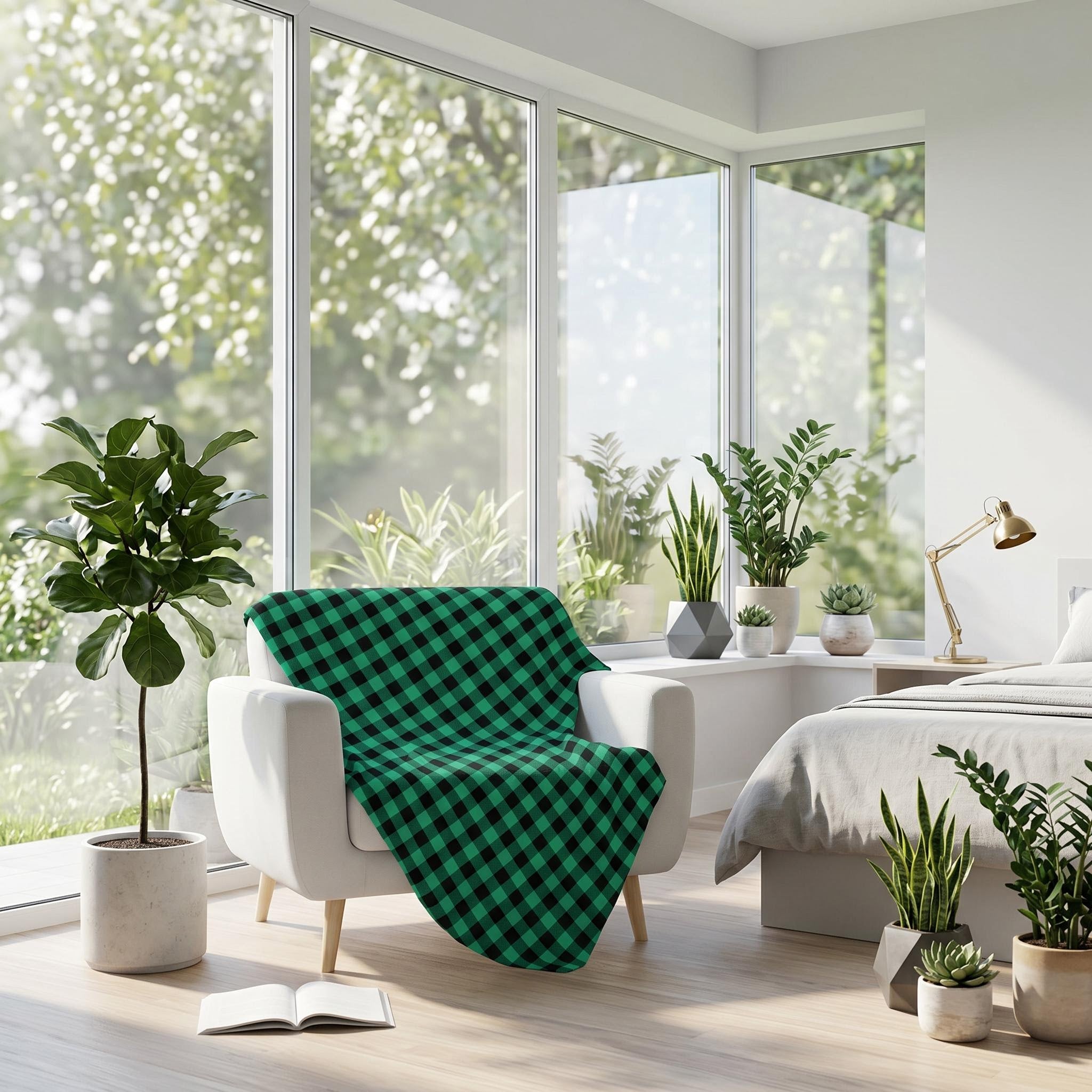 Green and black checkered flannel blanket draped over a white armchair in a bright, modern bedroom.