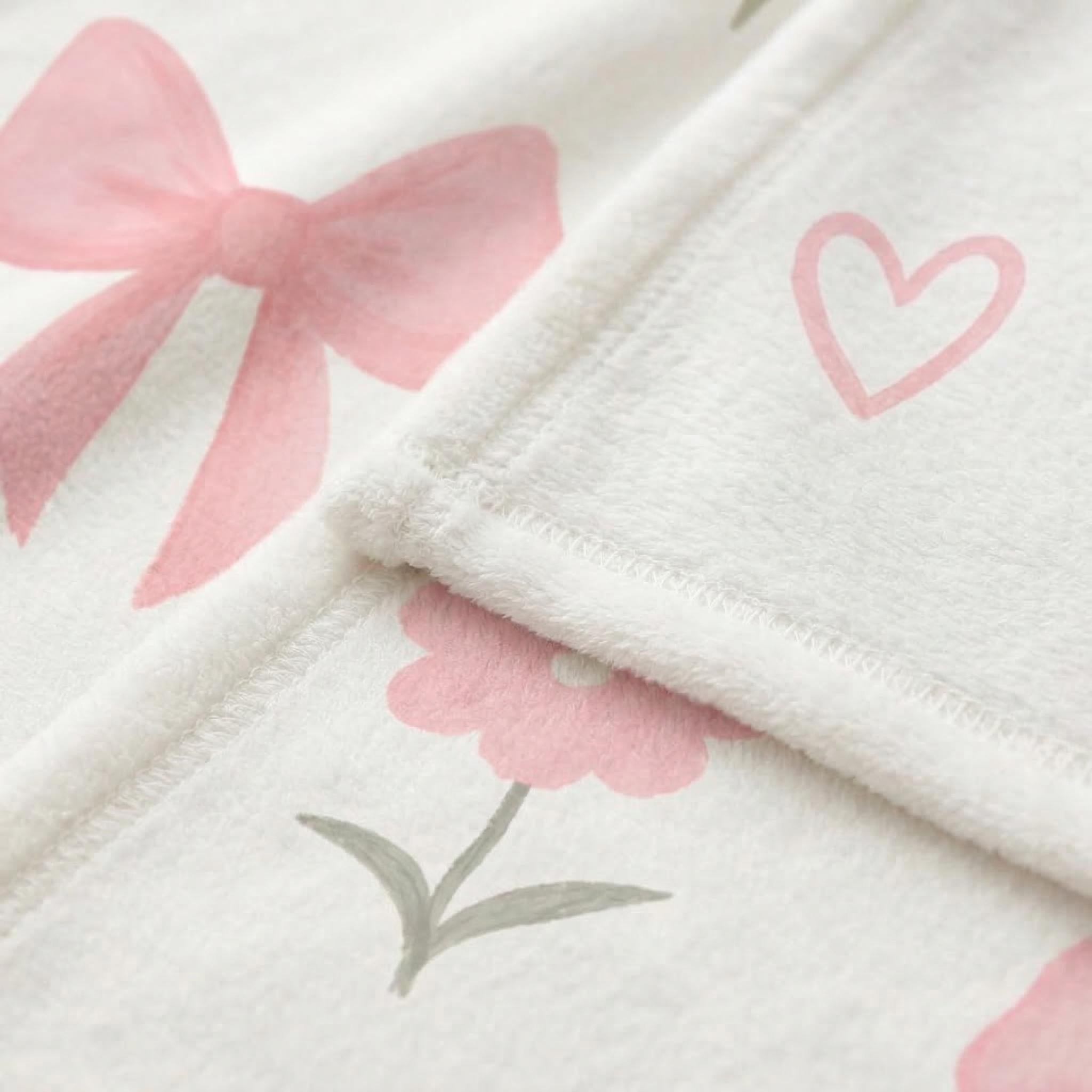 Soft white microfiber flannel blanket with pink bows, hearts, and flowers.