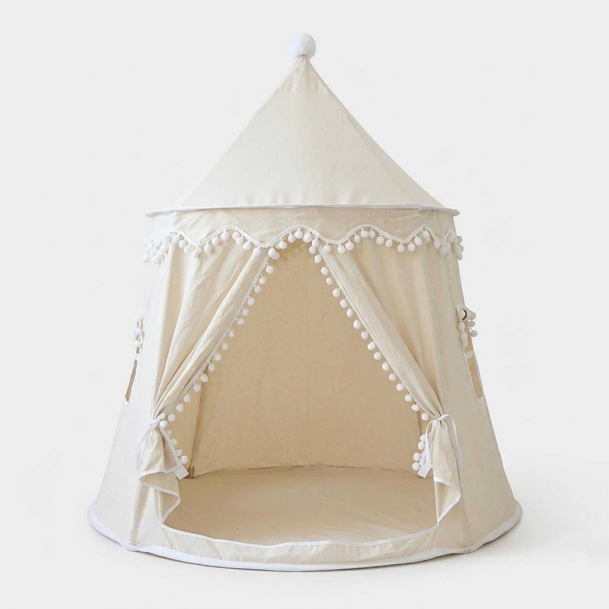 Cream indoor play tent with pom-pom trim, open front, and a pointed top with a single pom-pom.