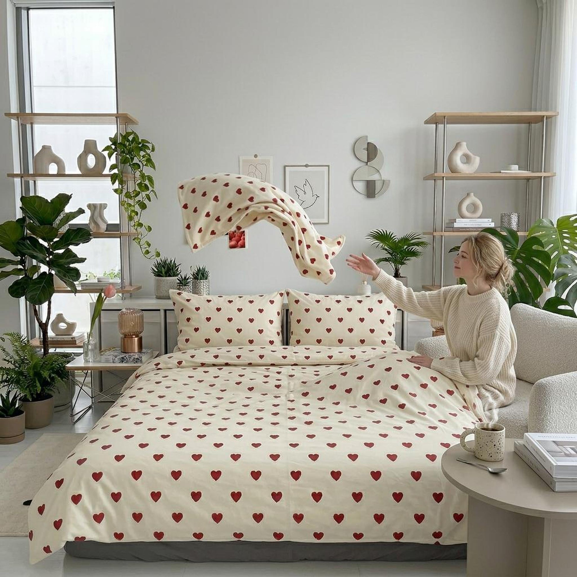 Korean Love Heart Bedding Set: Cream microfiber duvet cover with red heart pattern, pillowcases, and a woman tossing a sheet.