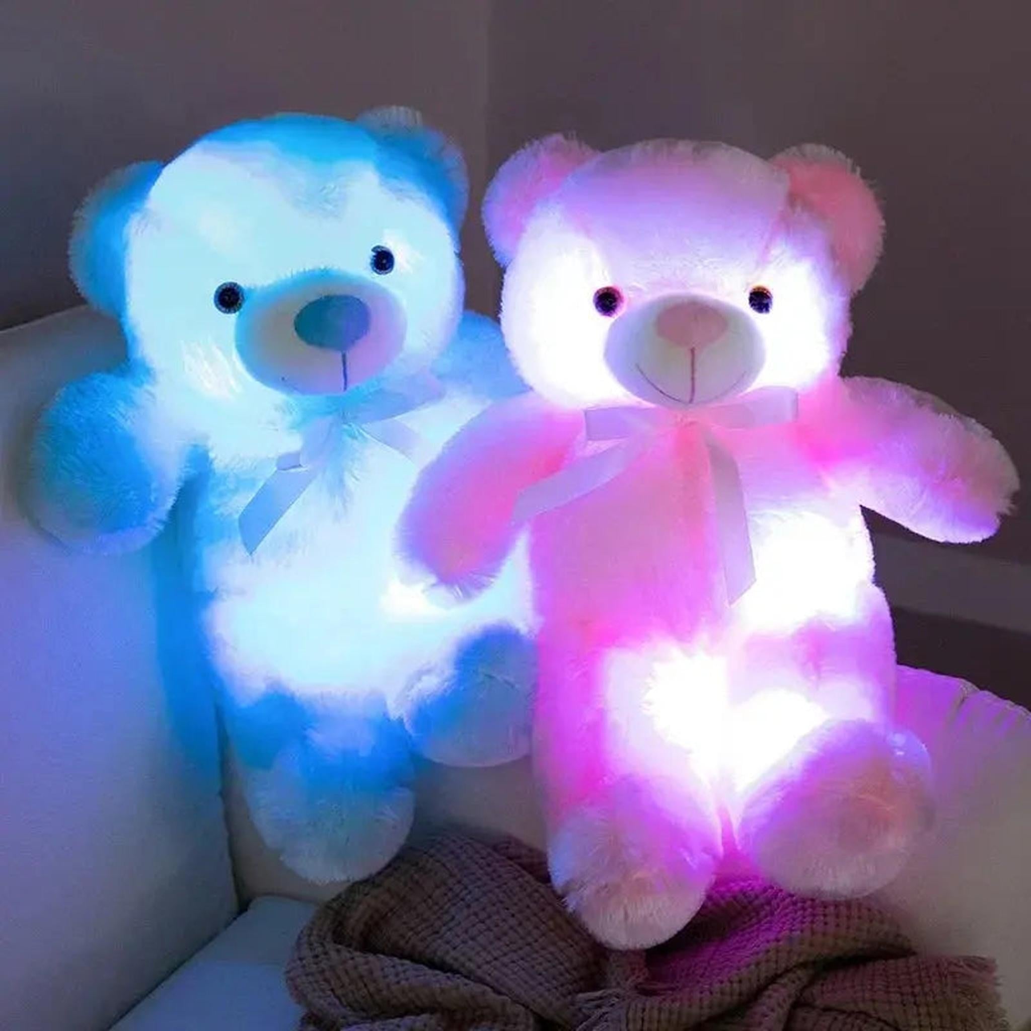 Two plush LED glowing teddy bears, one blue and one pink, with color-changing lights and white bows.
