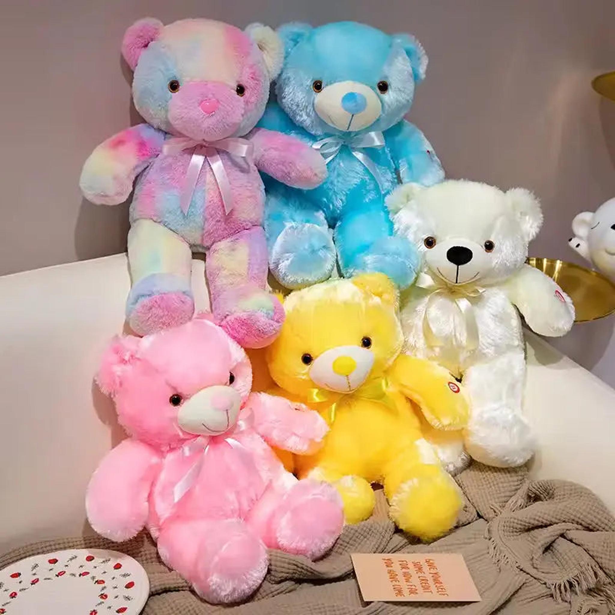 Five plush LED glowing teddy bears in rainbow, blue, white, pink, and yellow, with satin bows.
