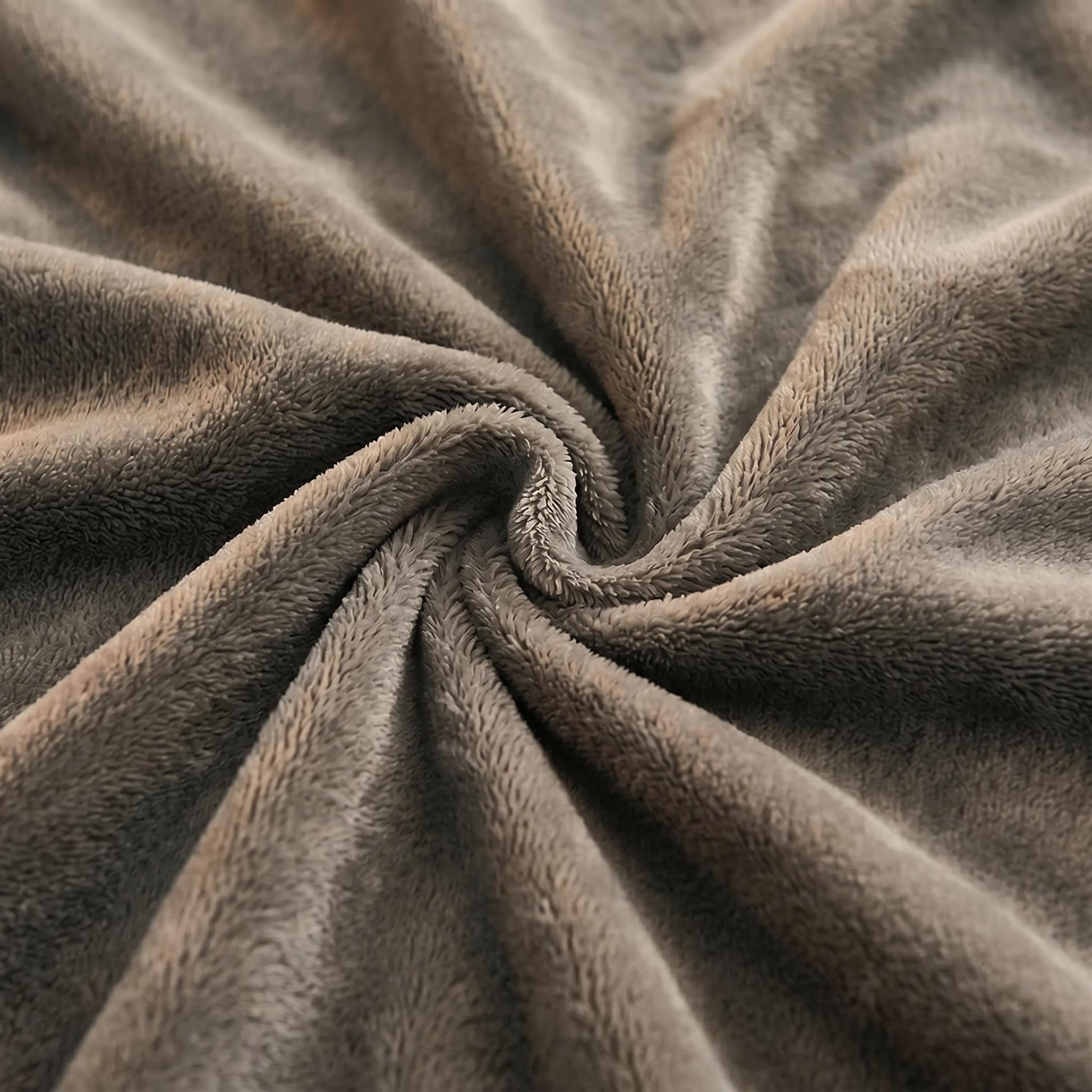 Close-up of a soft, brown lamb wool fleece blanket swirled into a plush spiral texture.