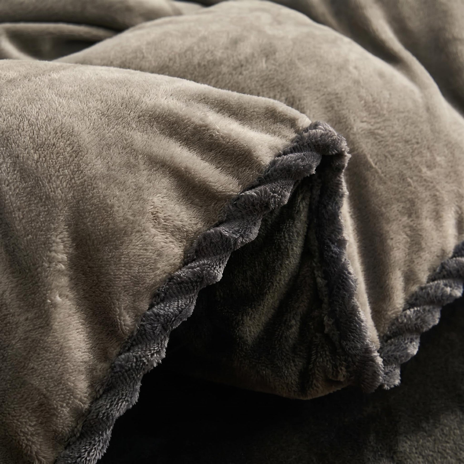 Thickened grey lamb wool fleece blanket with a soft plush texture and braided trim.