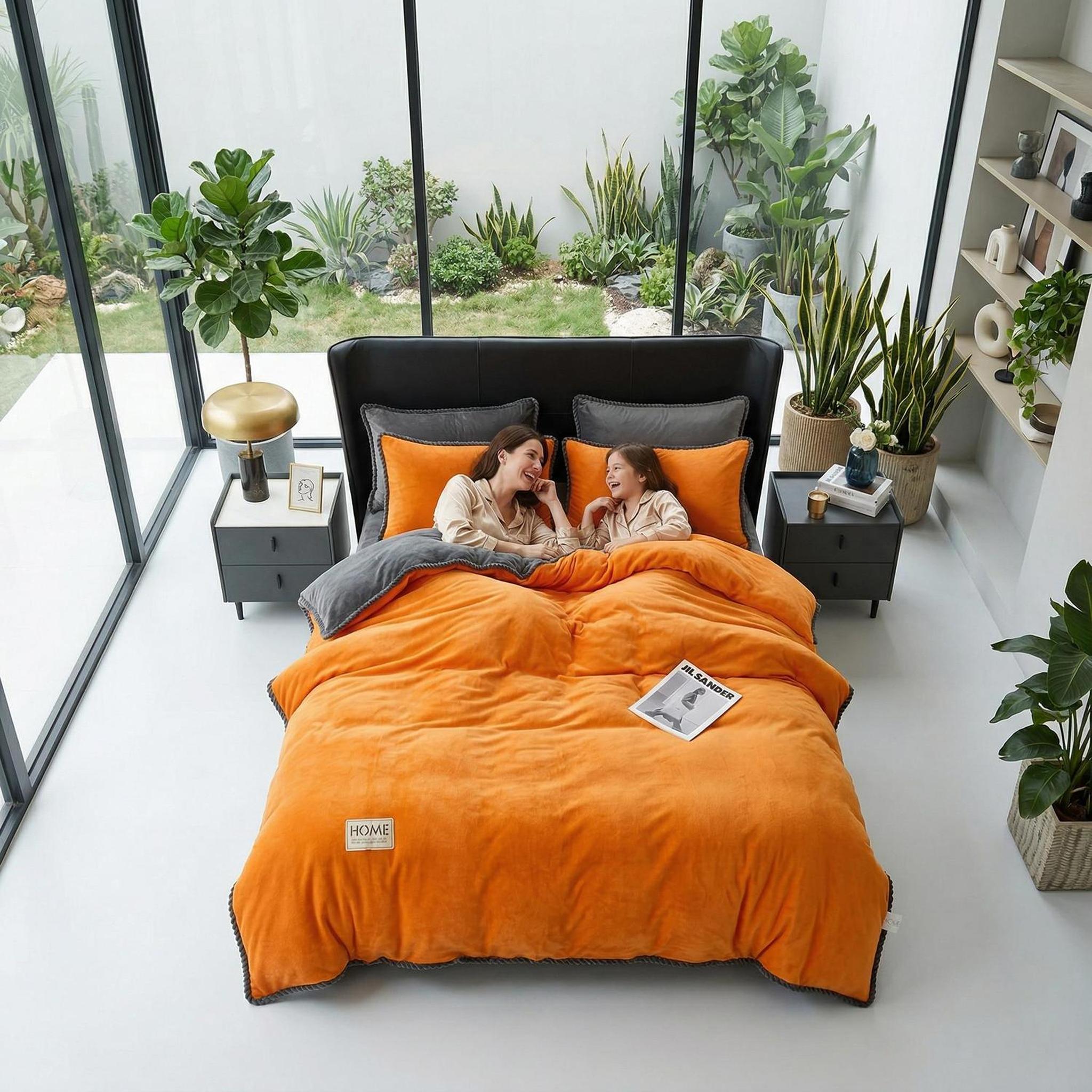 Orange and grey lamb wool thickened blanket on a bed in a modern room.