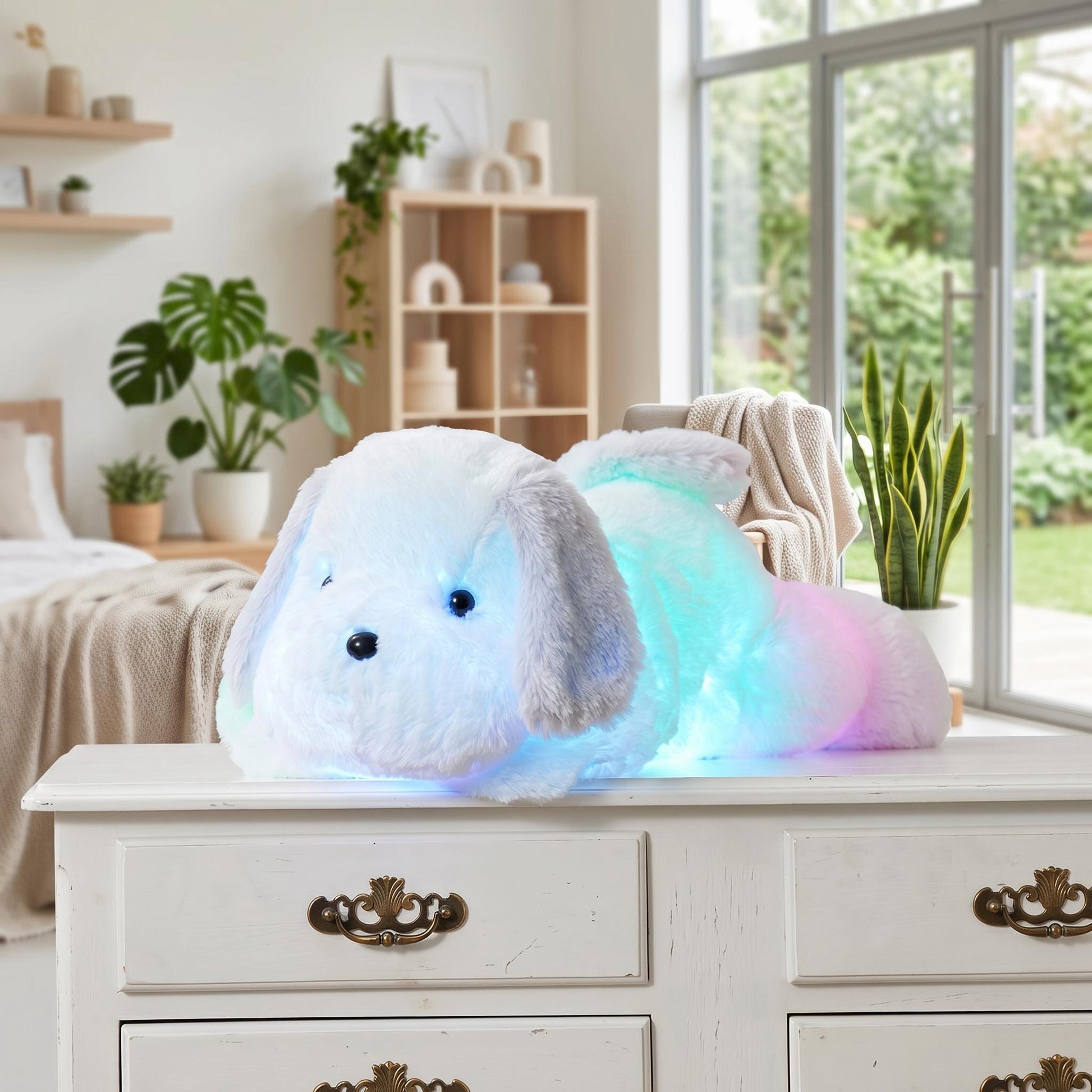 Luminous white plush dog pillow with glowing rainbow LED lights on a white dresser.