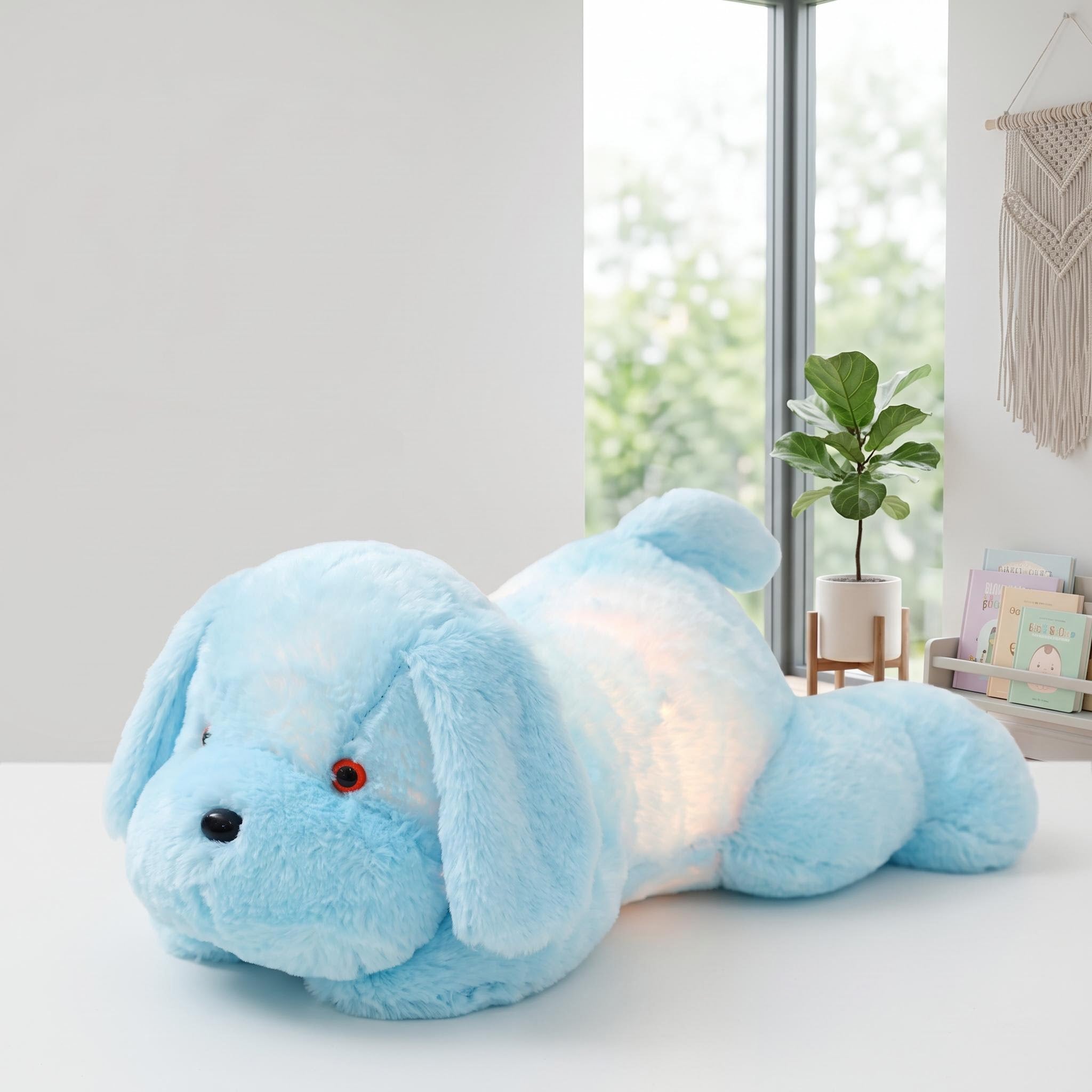 Light blue luminous dog plush pillow with glowing LED lights, lying on a white surface.