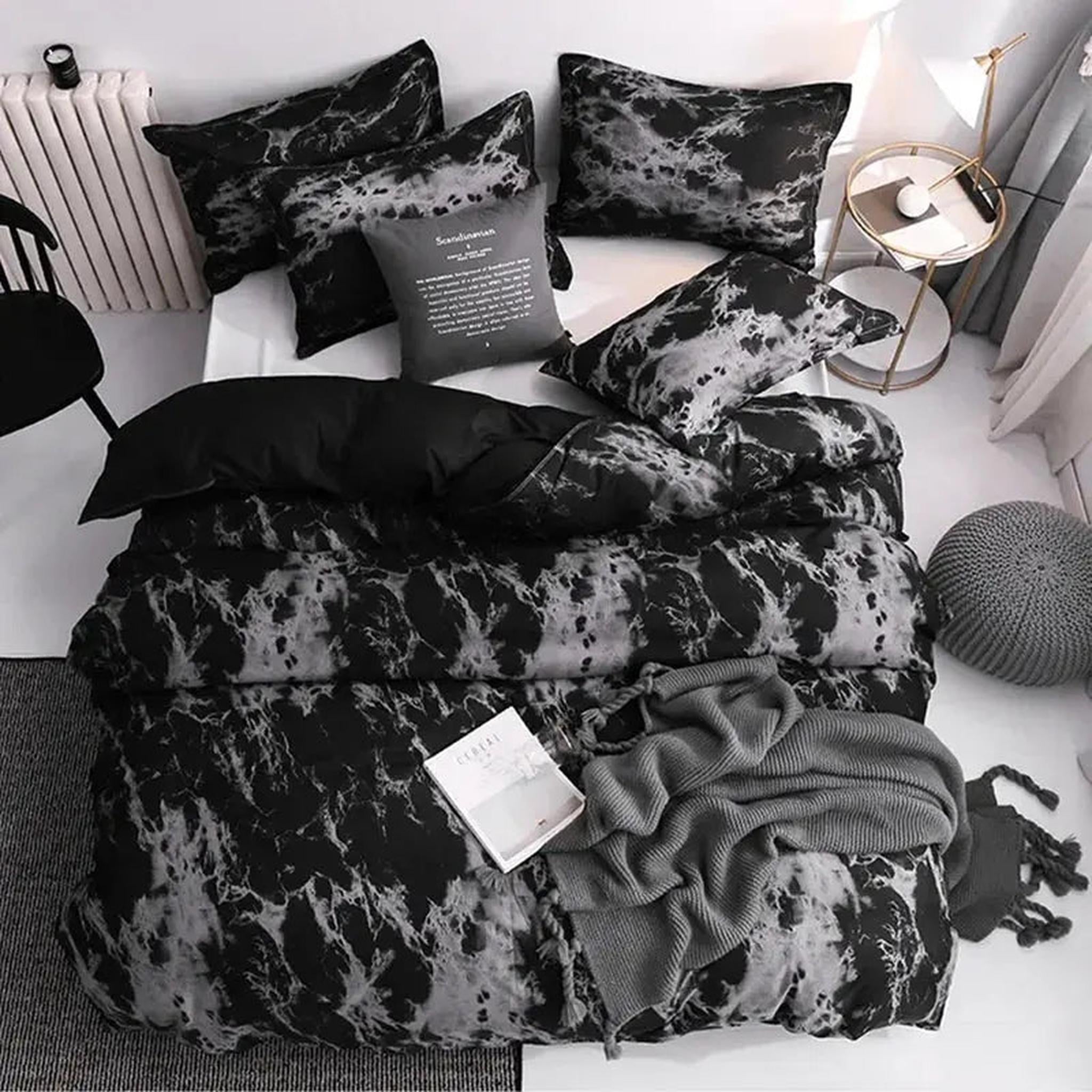Dark marble print microfiber duvet cover set with matching shams and a grey throw on a bed.