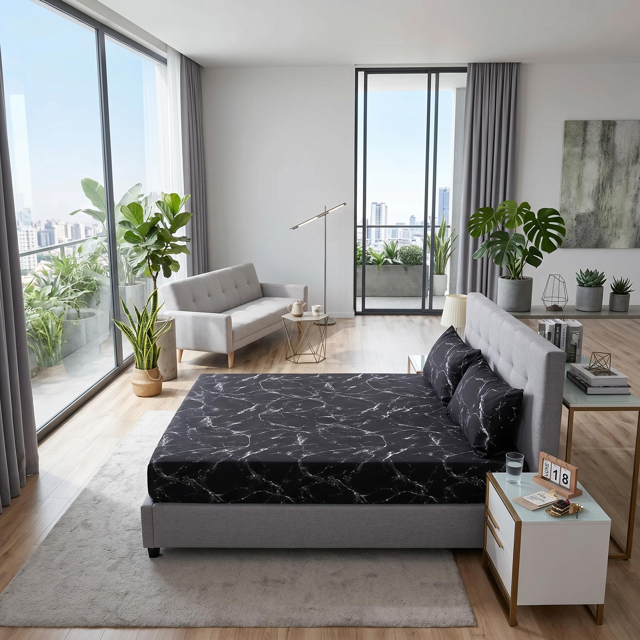 Black microfiber fitted sheet with white marble print on a grey bed in a modern bedroom.