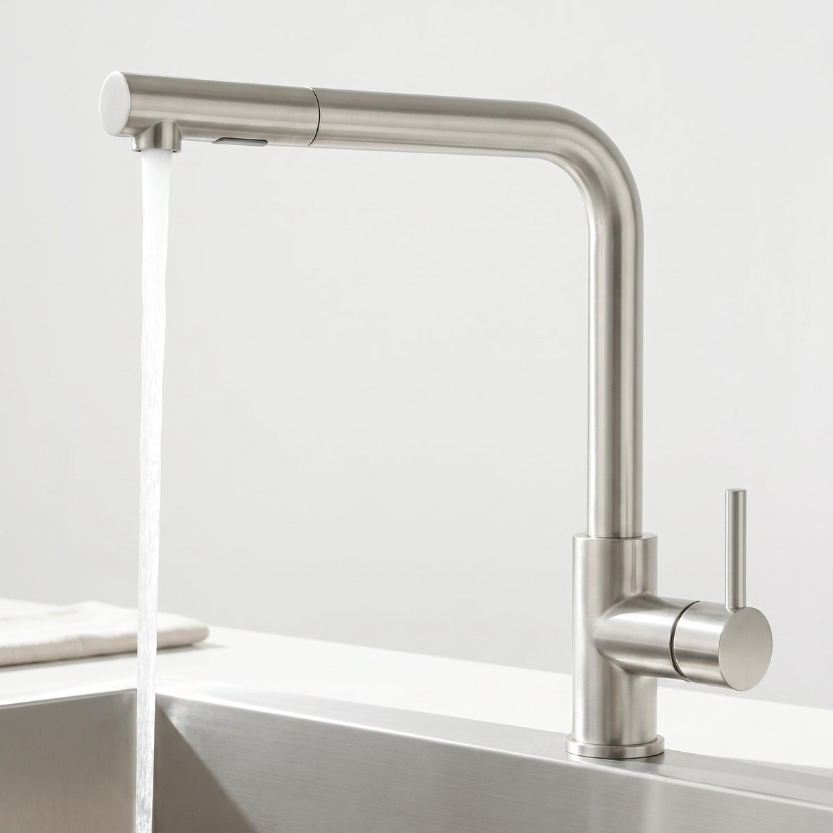 Modern stainless steel pull-out kitchen faucet with a sleek grey finish, single handle, and 360-degree swivel spout.