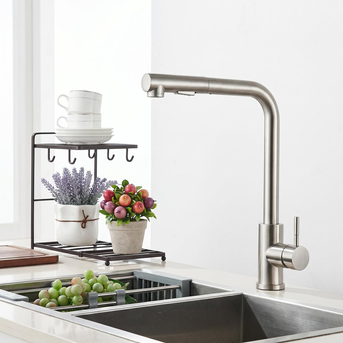 Modern stainless steel pull-out kitchen faucet with a sleek matte finish, 360-degree swivel spout, and single-handle control.