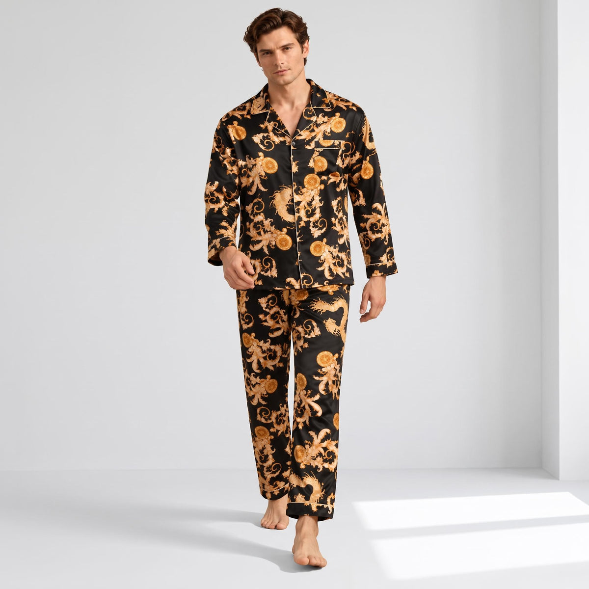 Man wearing a black and gold dragon print mulberry silk pajama set with a notch collar and button-down long-sleeve top.