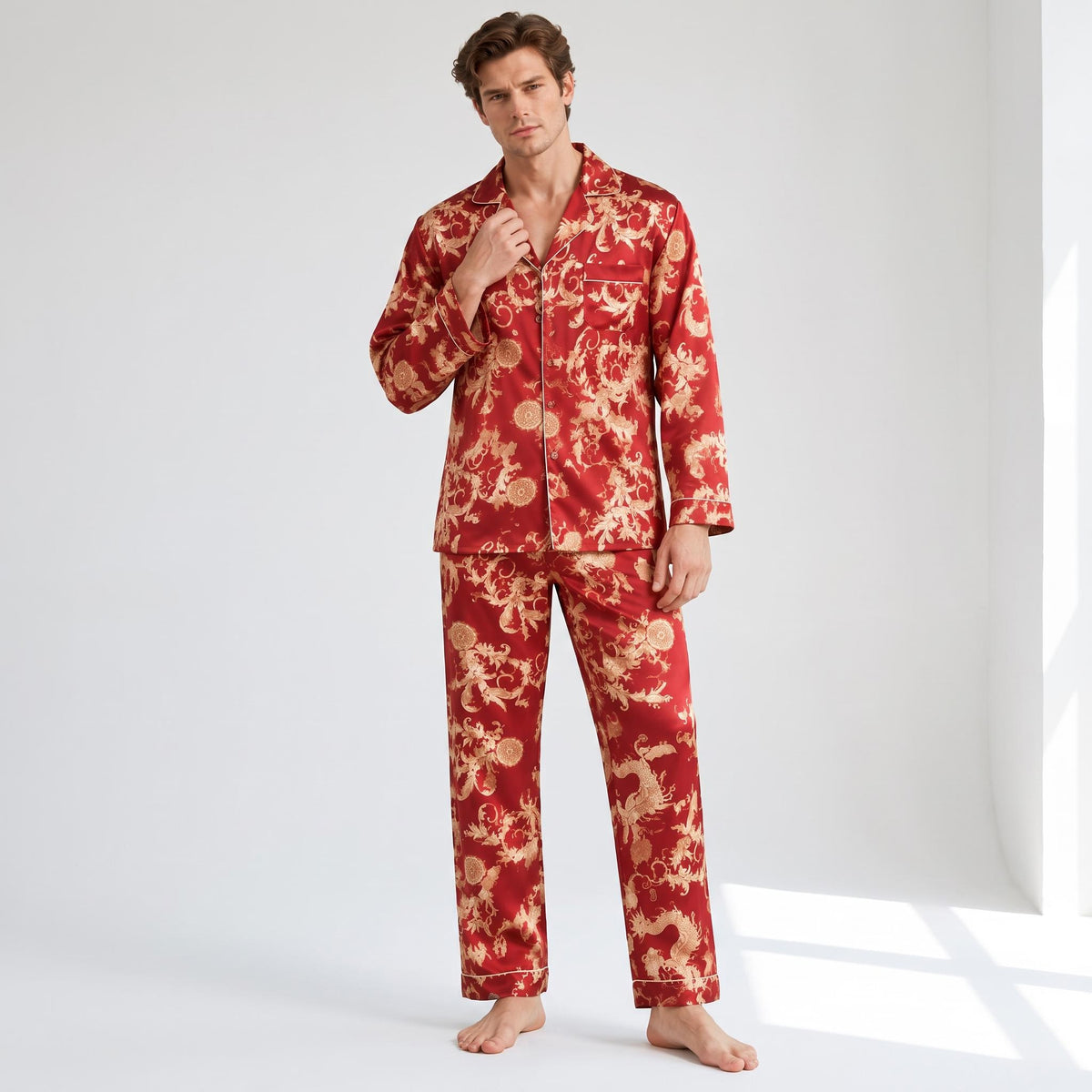 Man wearing a red mulberry silk pajama set with a gold dragon print, notch collar, and button-down design.