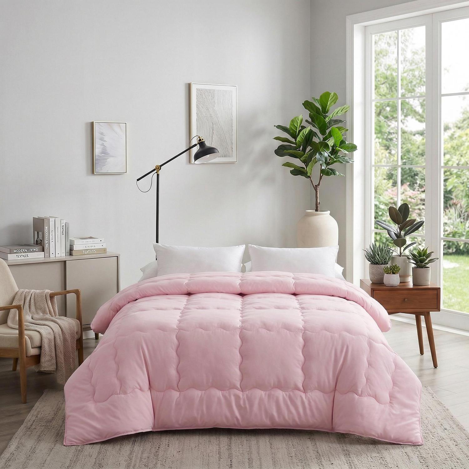 Pink minimalist solid color quilt comforter on a bed in a modern bedroom.