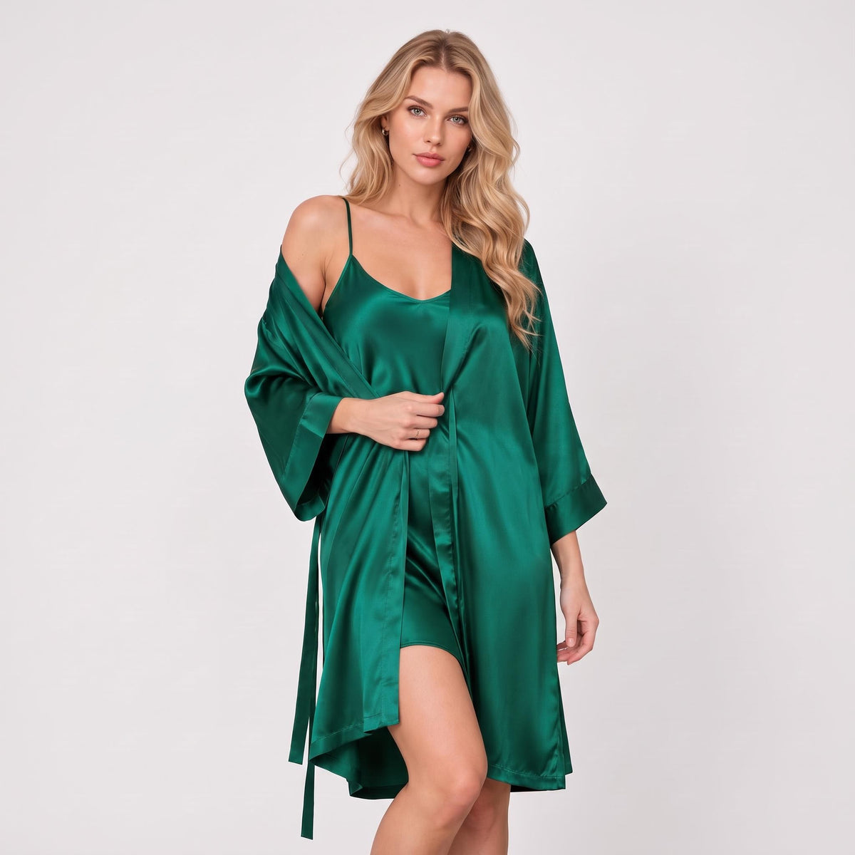 Woman wearing an emerald green mulberry silk kimono robe and matching spaghetti strap nightgown set.