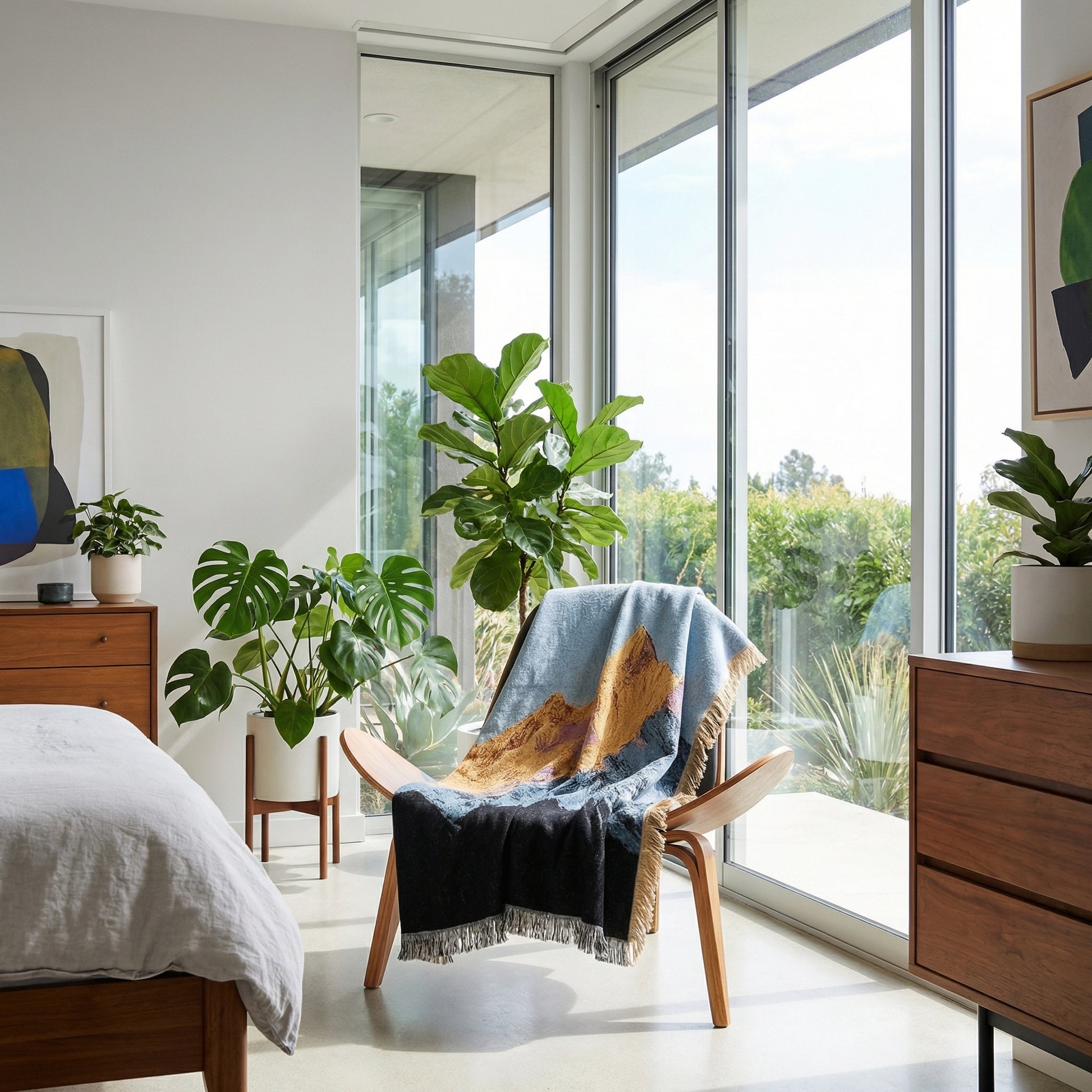 Natural Landscape Knitted Blanket with mountain design draped over a wooden chair in a bright room.