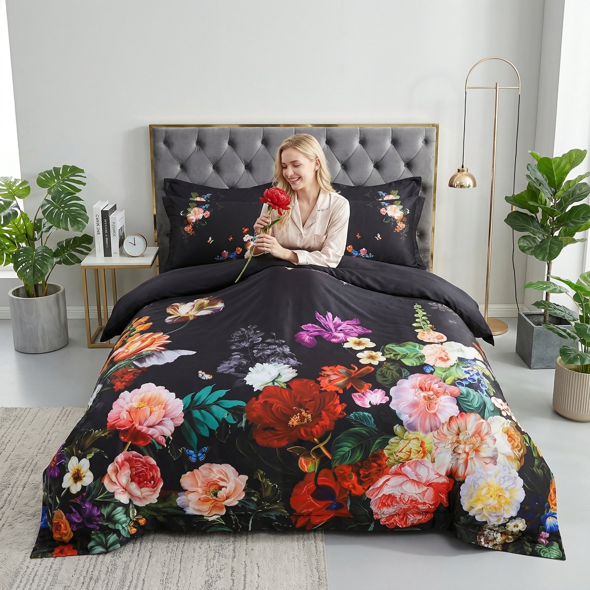 Black Egyptian Cotton duvet cover with vibrant floral and bird mosaic design, featuring a smiling woman holding a red flower.