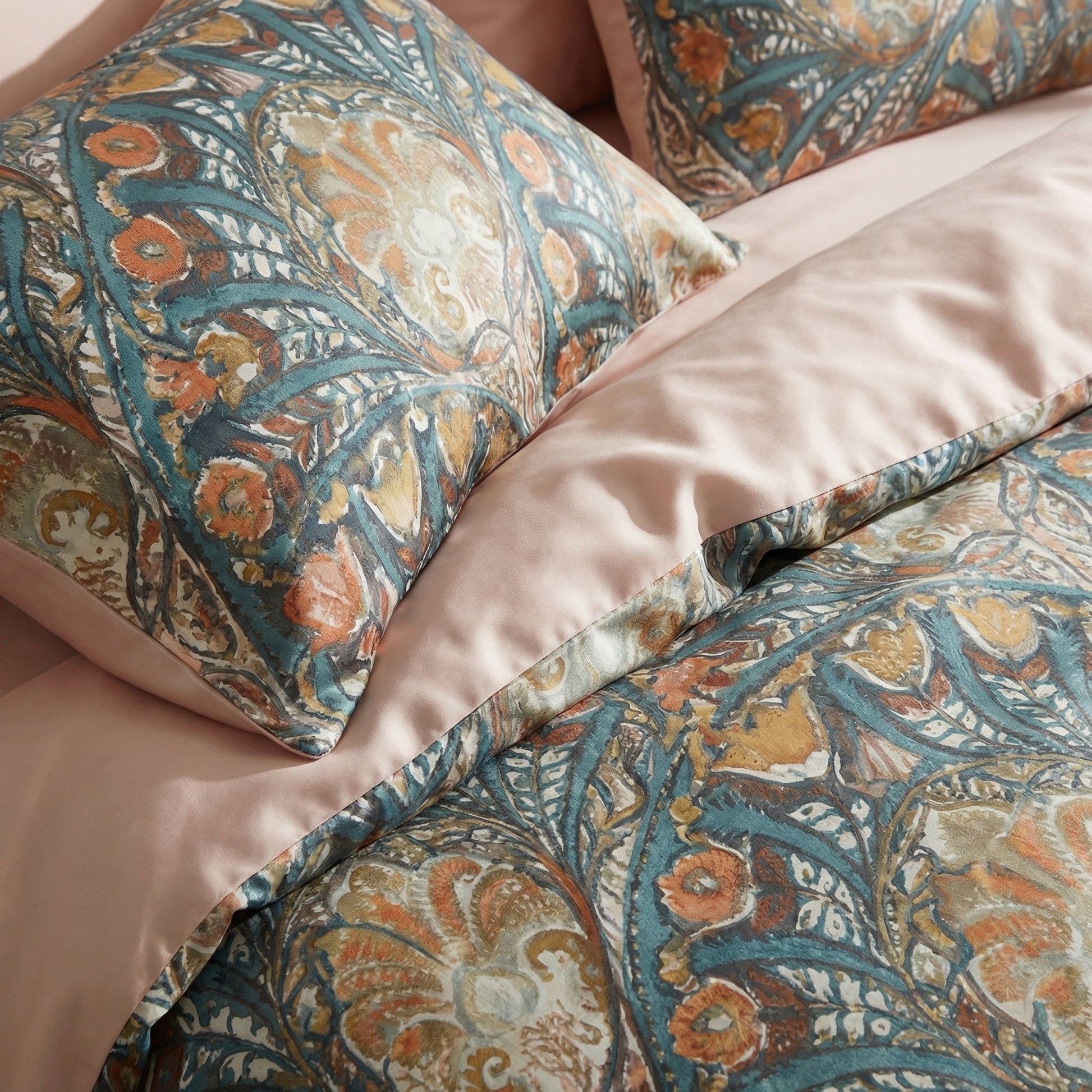 Egyptian cotton Peacock Tail bedding with navy, burnt orange, ochre, and teal botanical pattern, blush reverse.