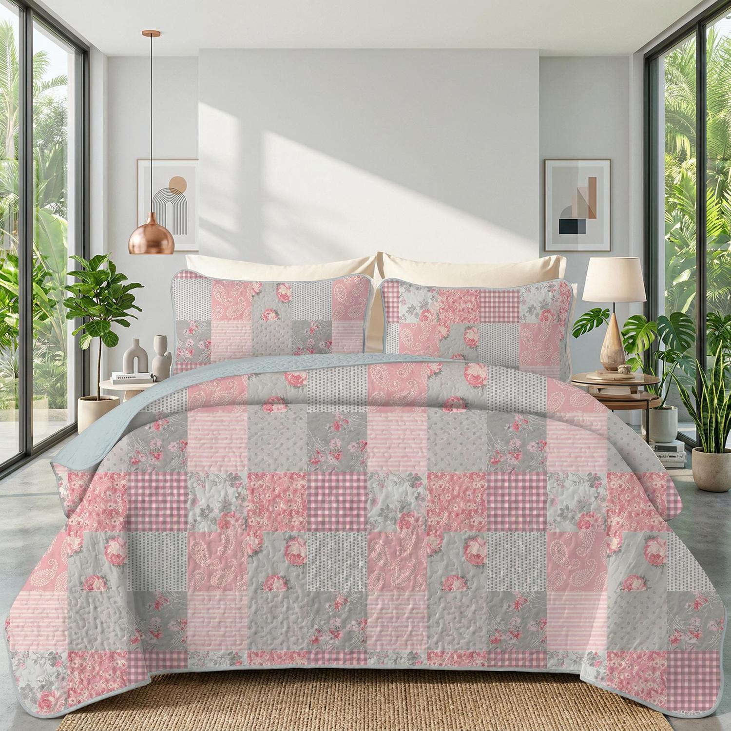 Pink flowers printed microfiber quilt set with two pillowcases on a bed.