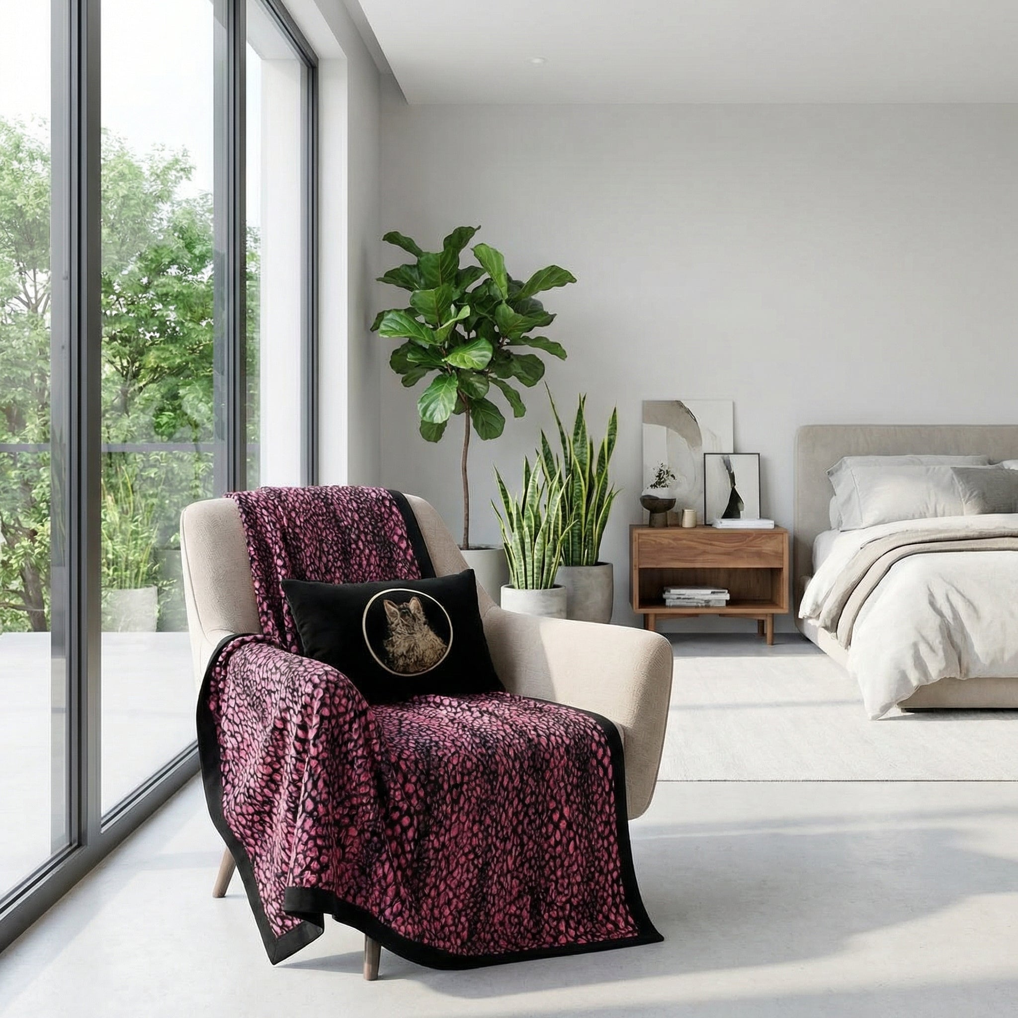 Pink leopard print plush blanket draped over a beige armchair in a modern bedroom.