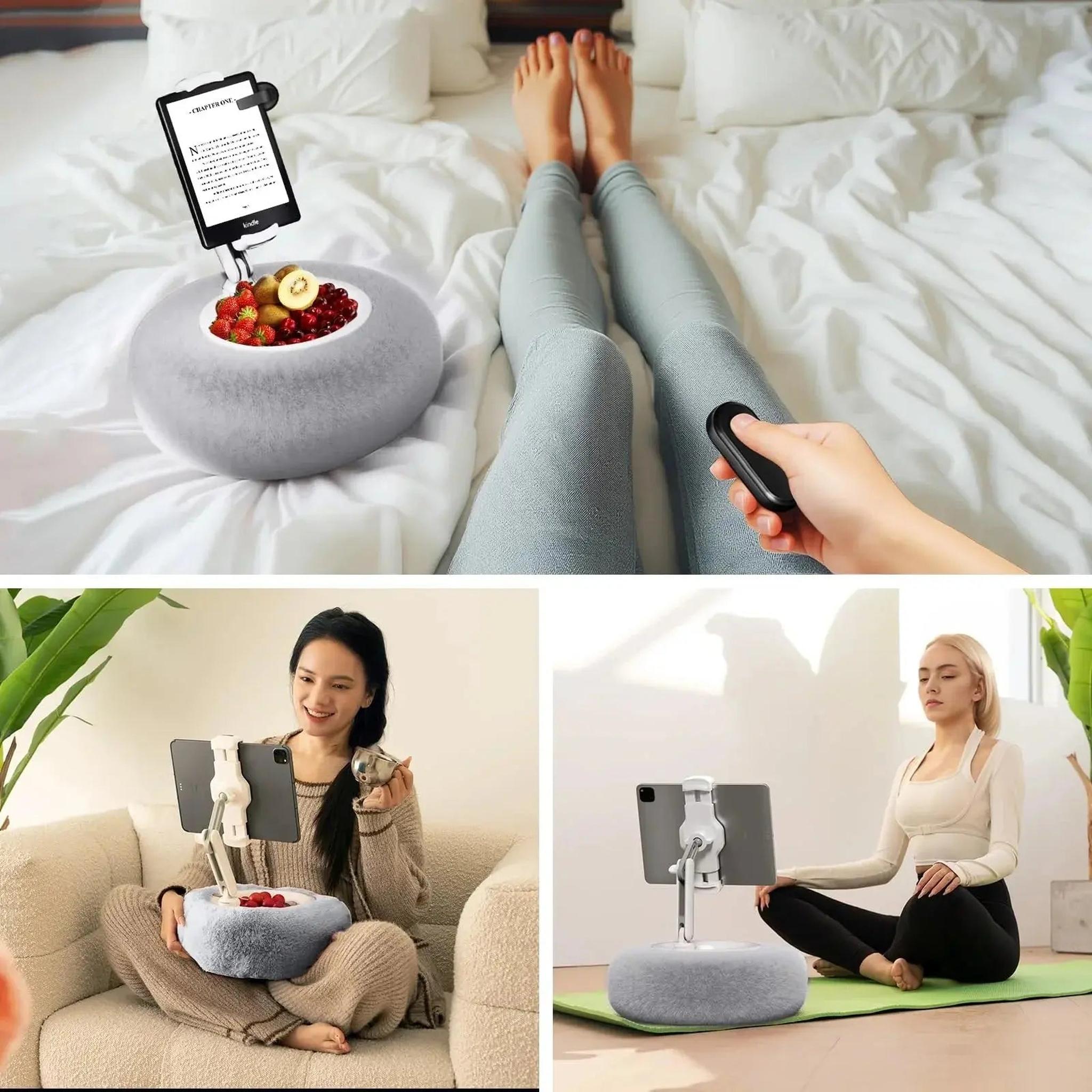 Gray plush adjustable device pillow stand with a tablet holder, shown in bed, on a sofa, and on a yoga mat.
