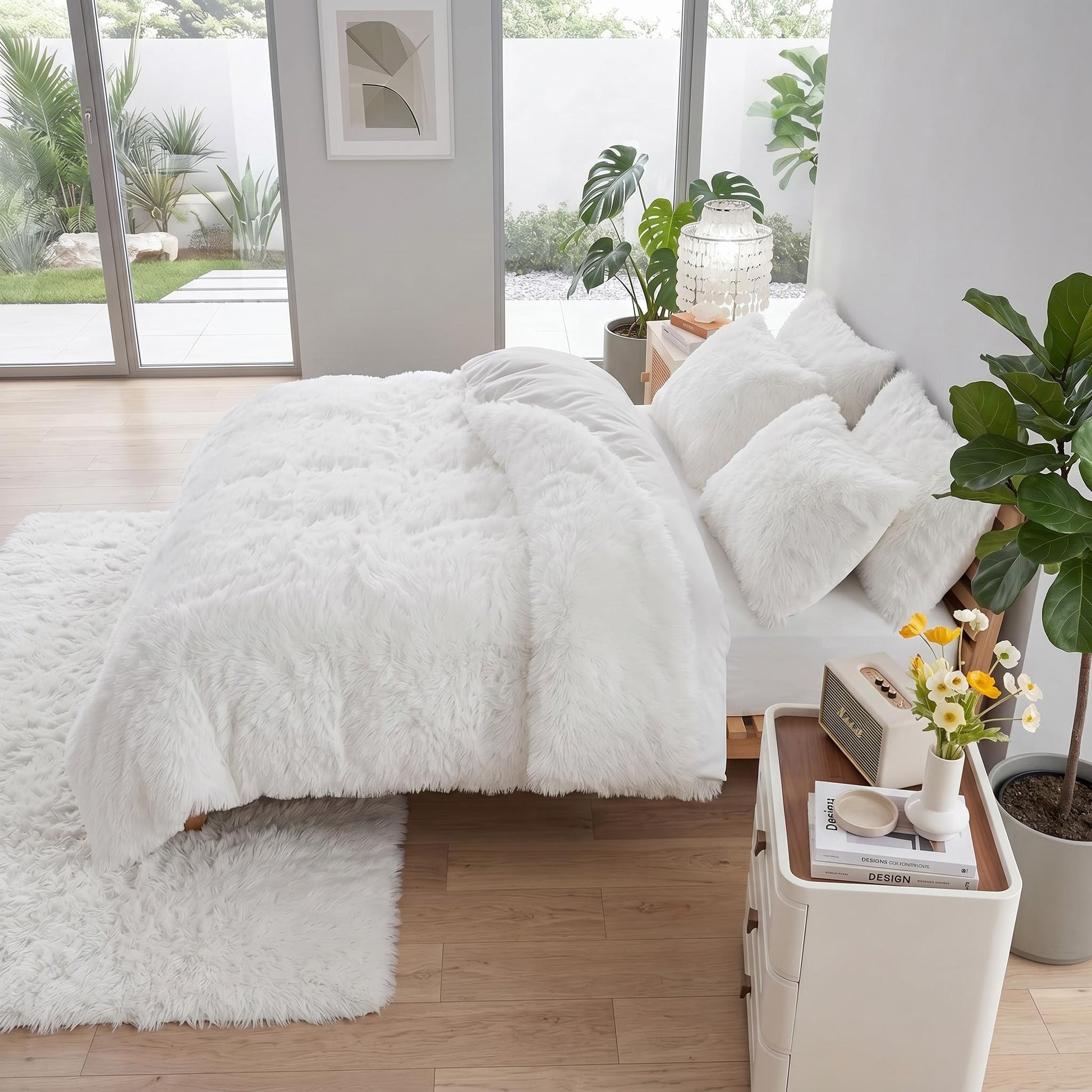 White reversible faux fur and velvet plush duvet cover set with matching pillows and rug in a modern bedroom.