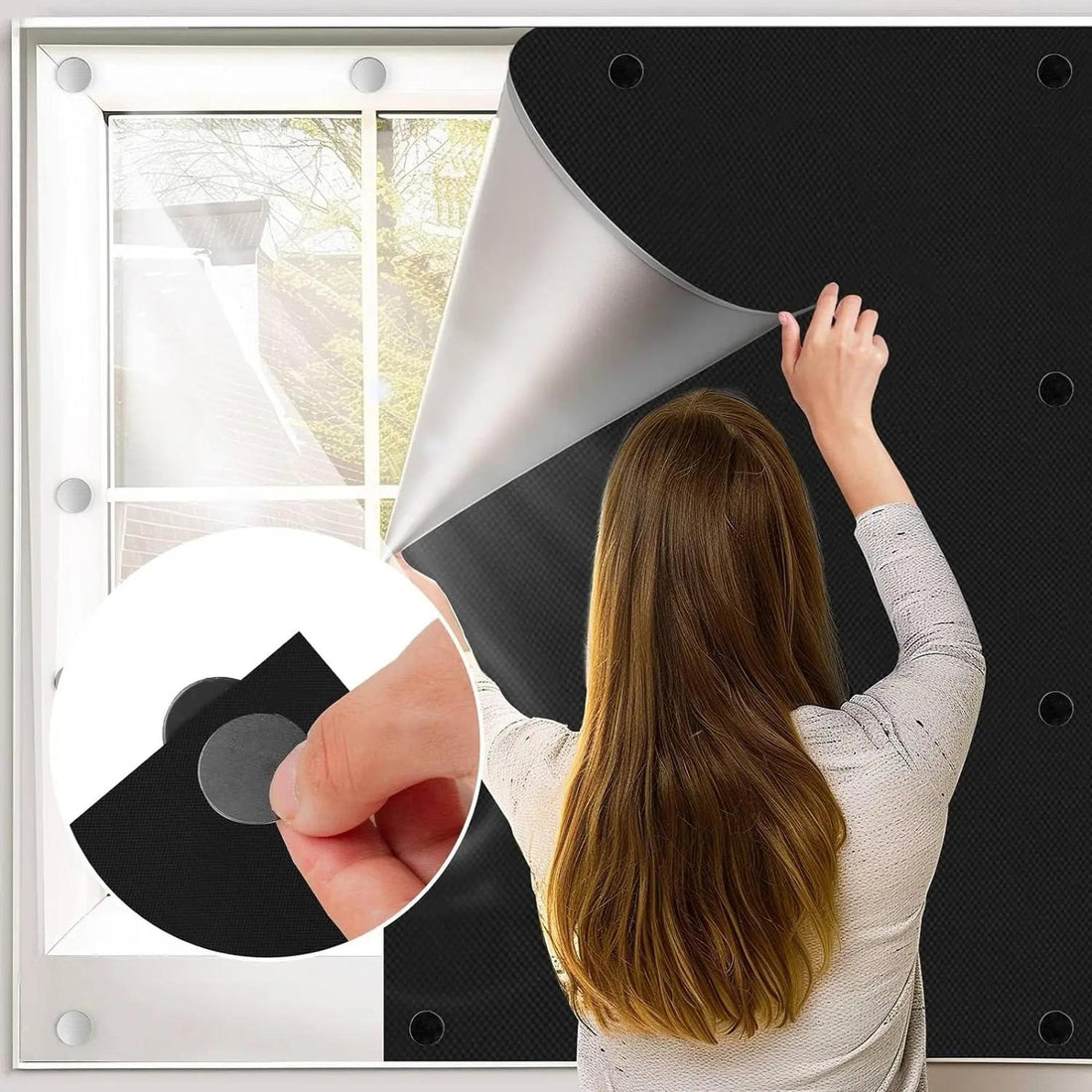 Woman installing a black magnetic blackout shade on a glass bedroom window for light control and privacy.