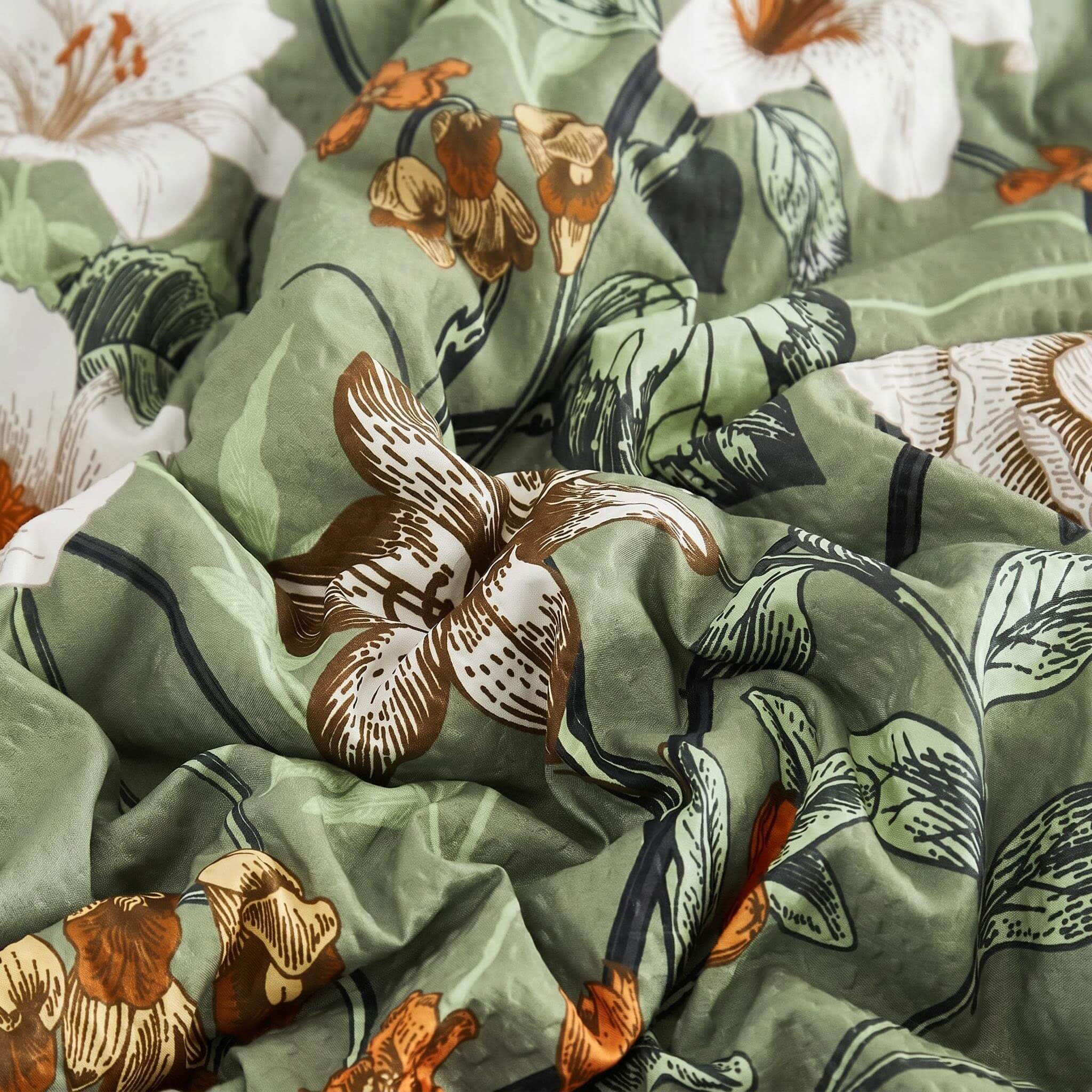 Green rainforest floral printed microfiber quilt with white and brown flowers.
