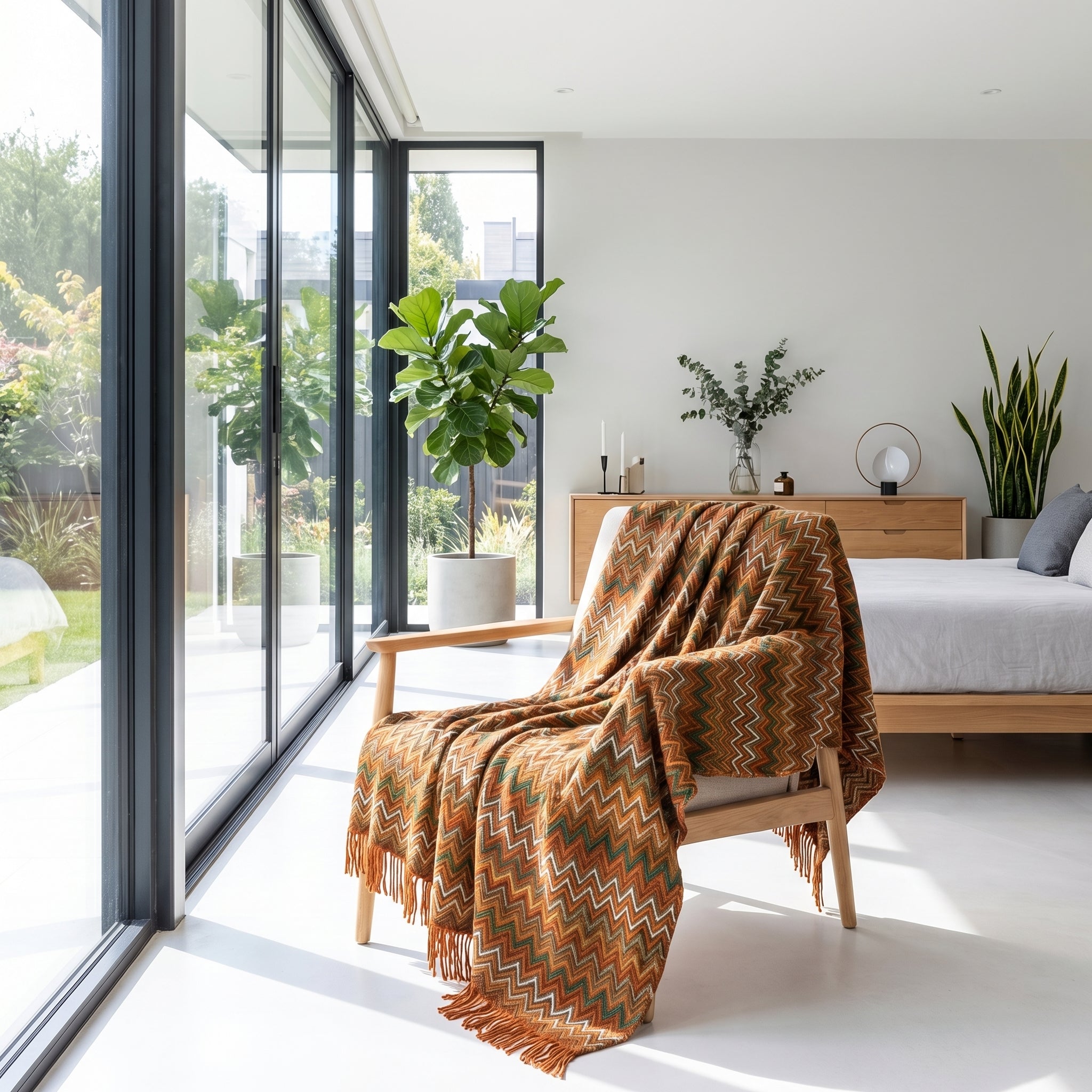 Retro bohemian striped knitted blanket with tassels draped over a wooden armchair in a bright room.