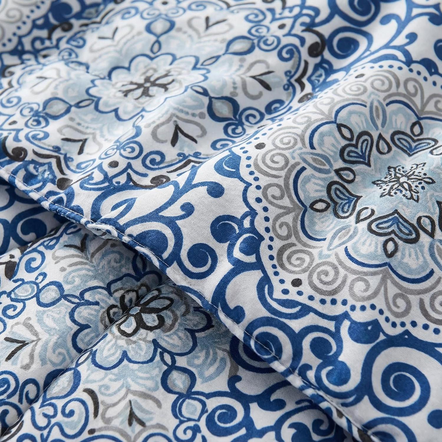 Close-up of a reversible comforter with a blue and white medallion pattern, soft down-alternative filling.
